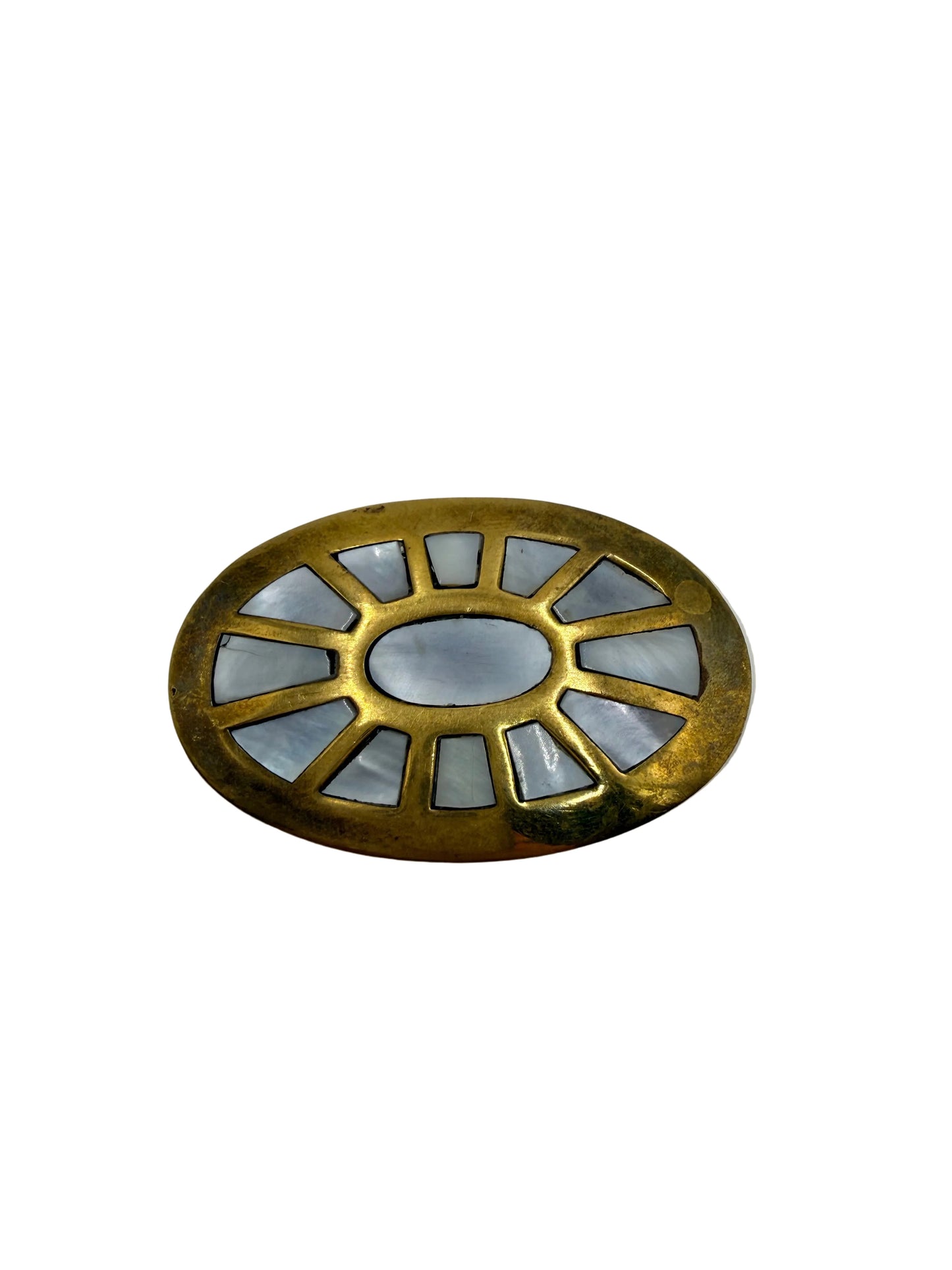 Decorative metal object with a geometric design on a gray background