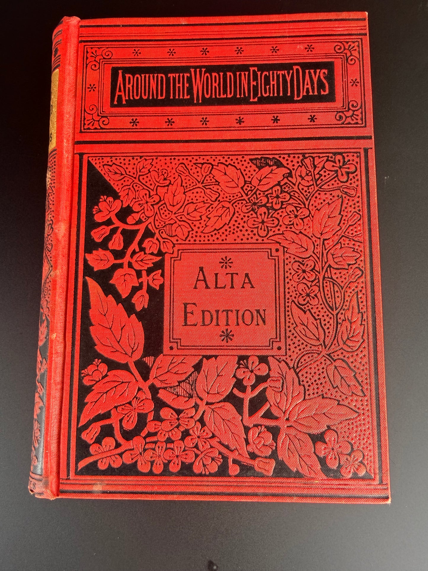 Decorative red book with floral patterns on a black background