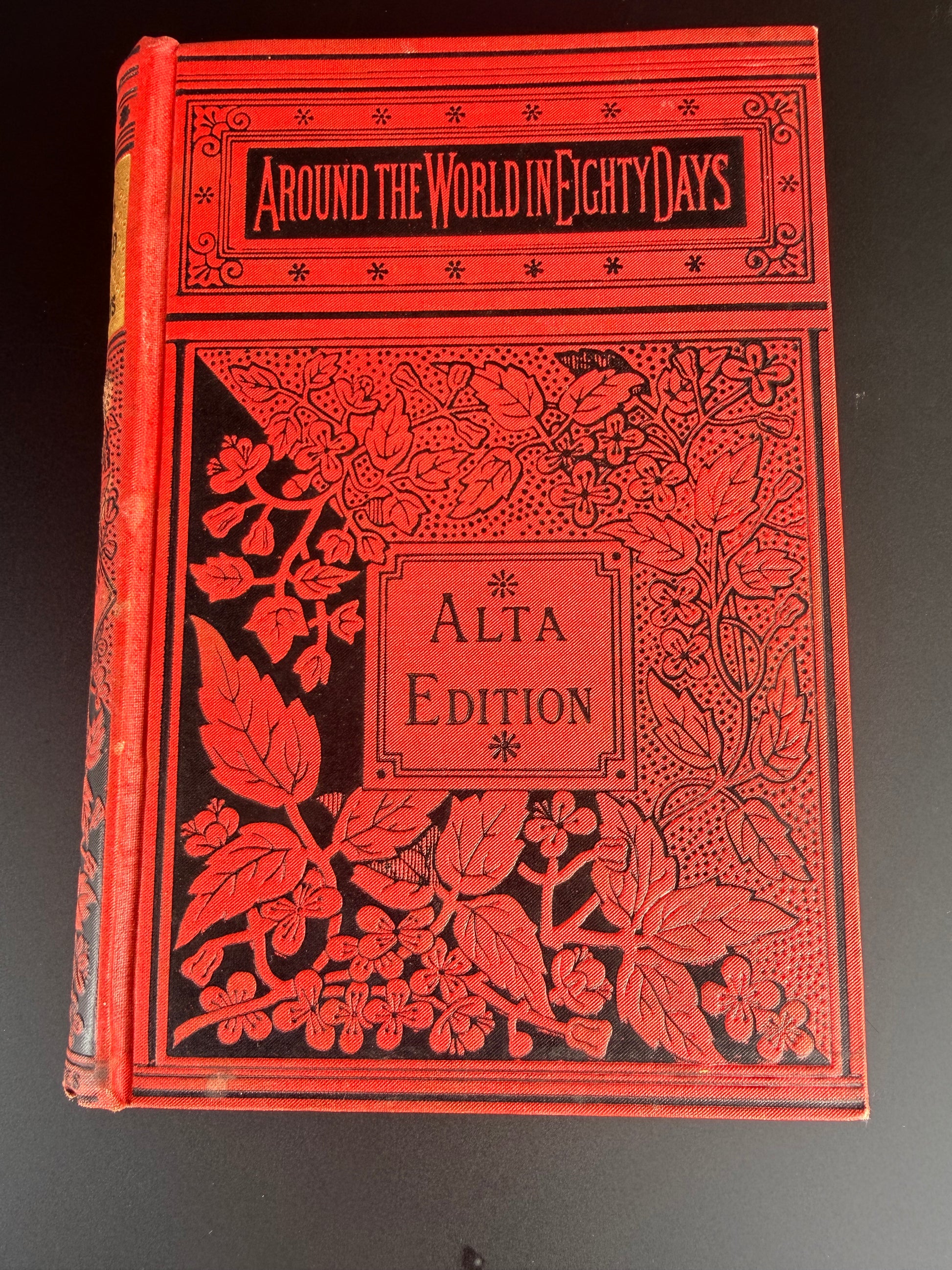 Decorative red book with floral patterns on a black background