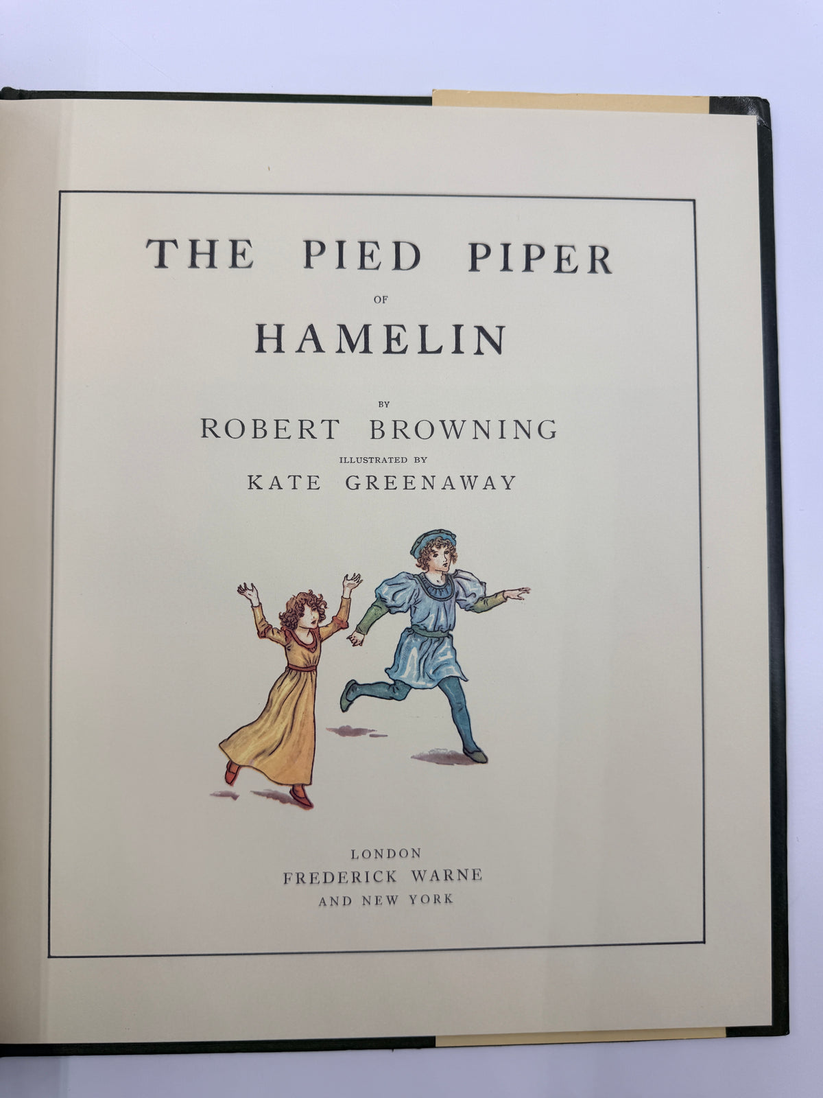 The front cover of a book titled 'The Pied Piper of Hamelin' by Robert Browning, illustrated by Kate Greenaway, published by Frederick Warne. The cover features a cream background with black text and a small illustration of the two children running.