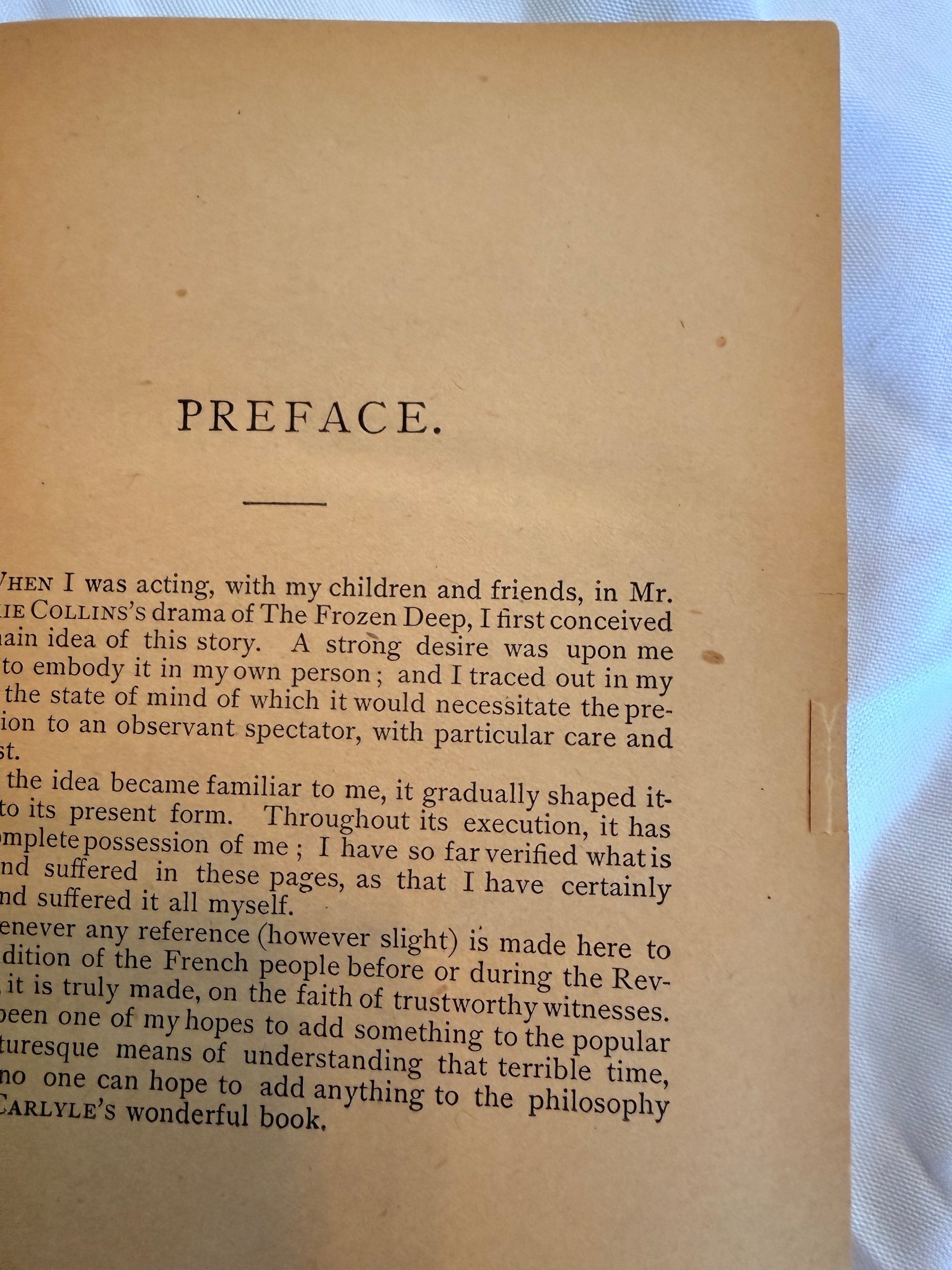 Book page with 'Preface' text on a textured surface
