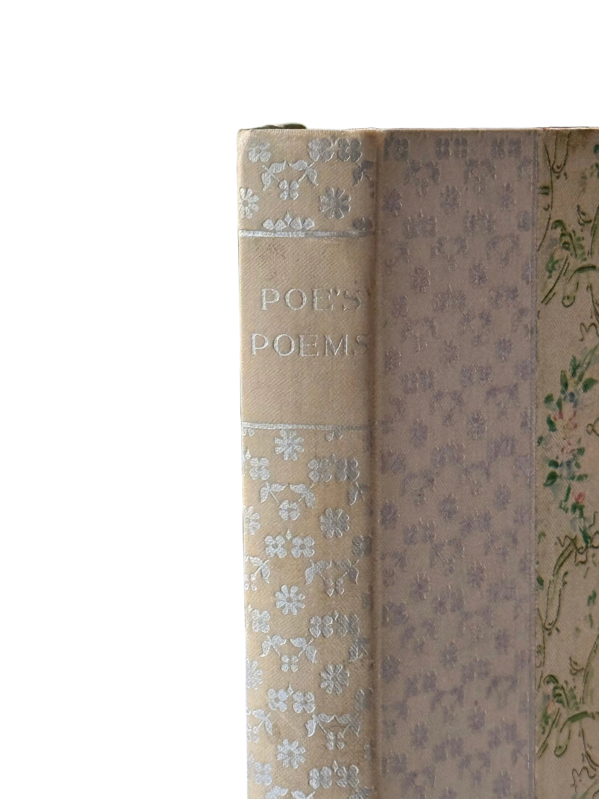 Vintage book titled 'POEMS' with decorative cover design, placed by a window.