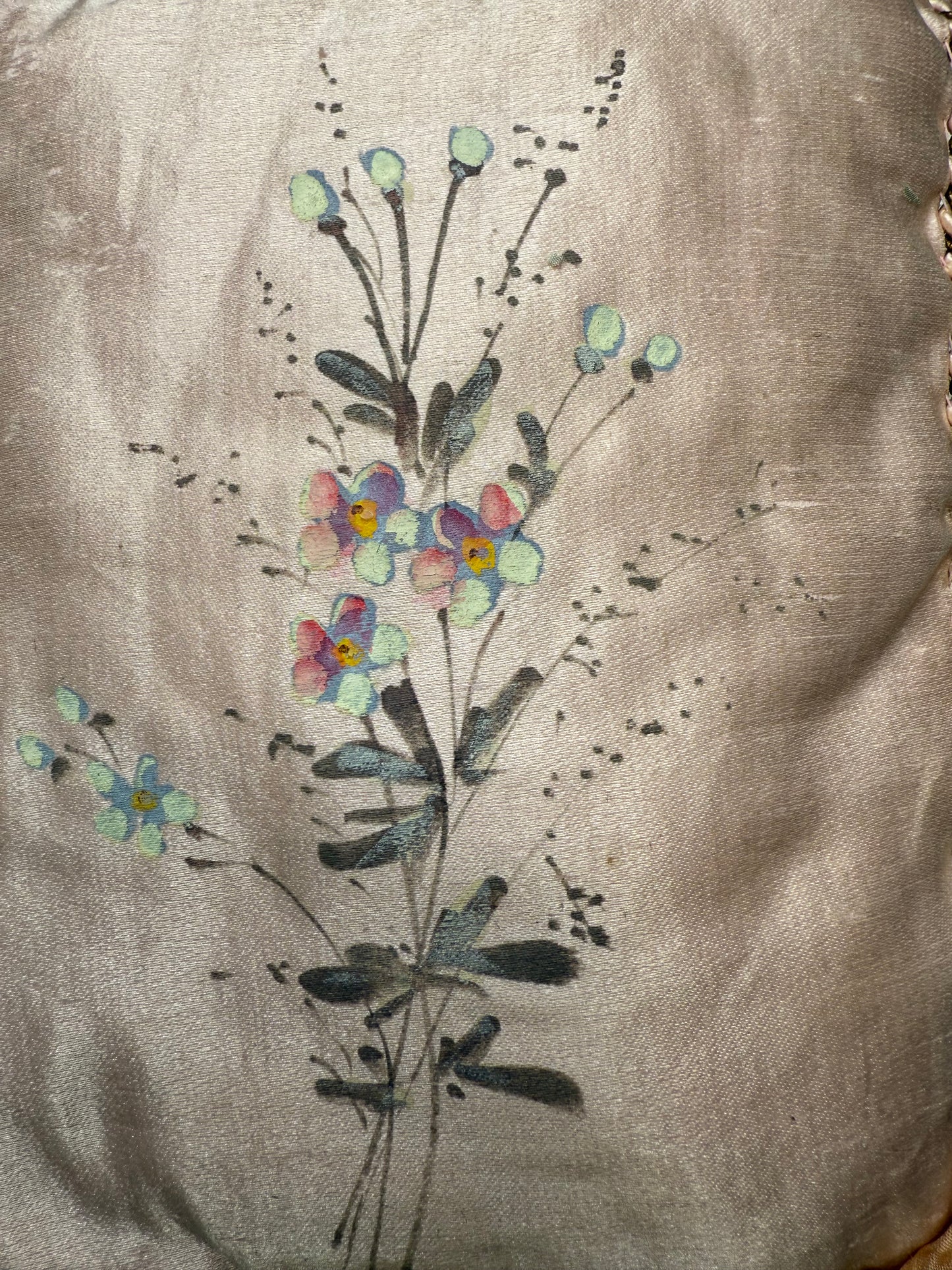 Embroidered floral design on a fabric background