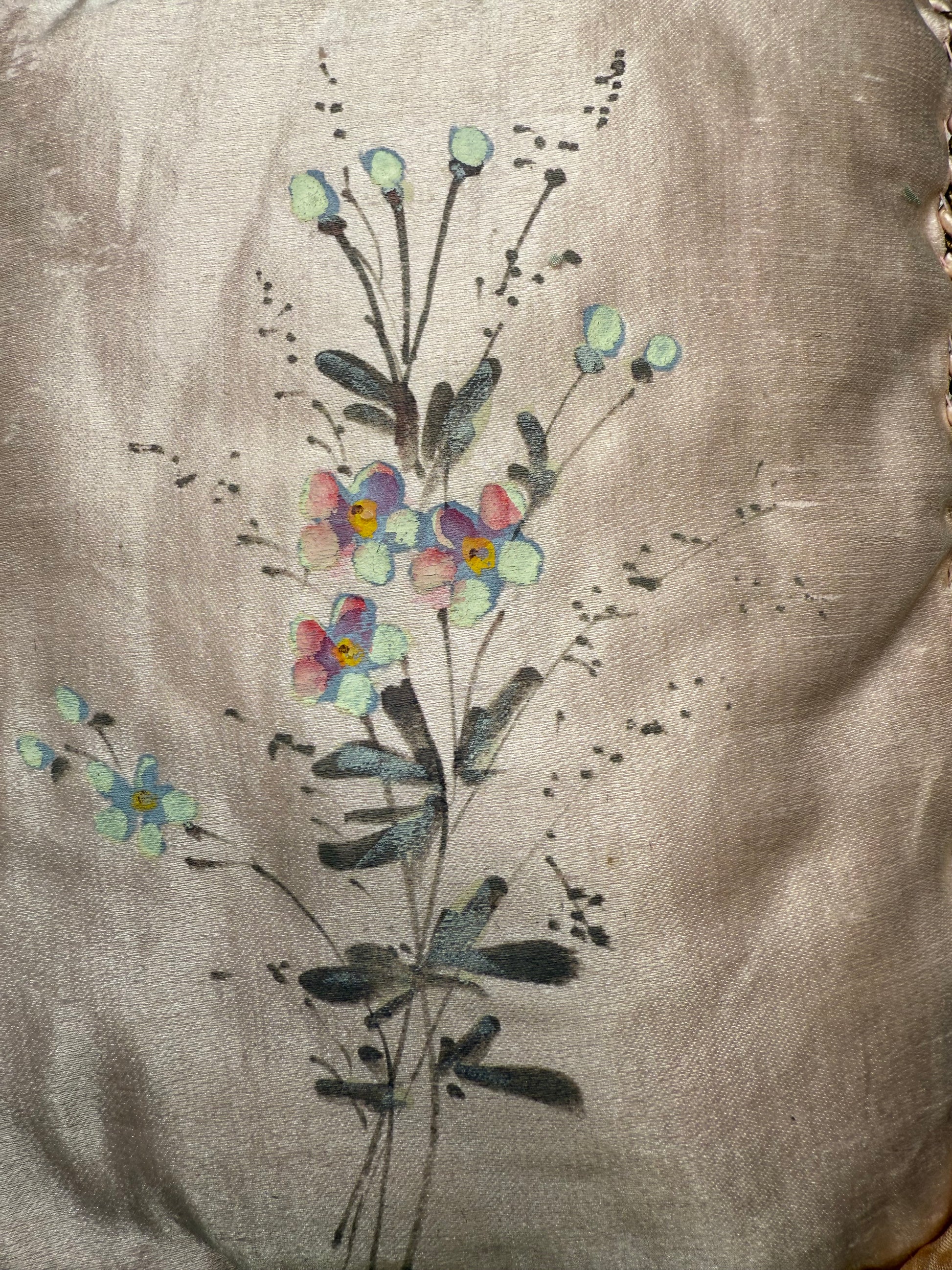 Embroidered floral design on a fabric background