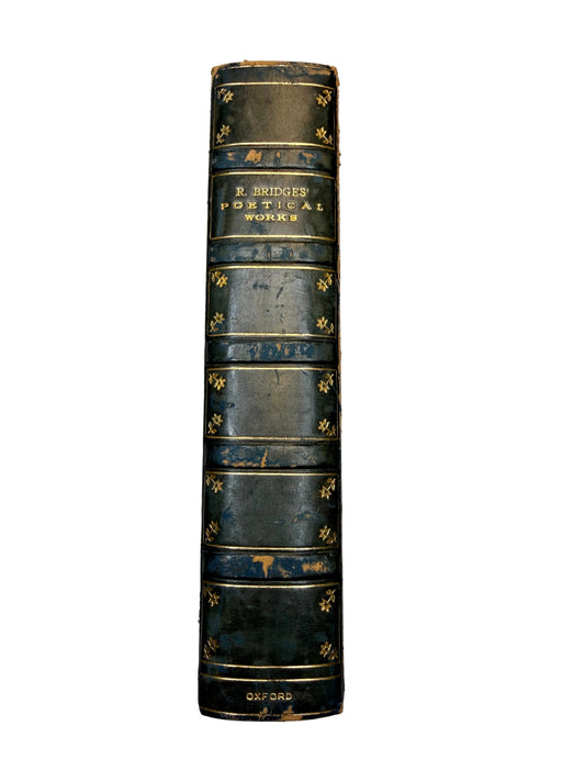Vintage leather-bound book with gold embossed text on a plain background