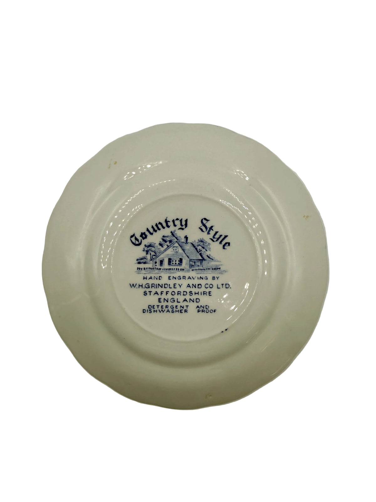 The bottom of a white ceramic plate featuring a blue printed label with the text 'St. Louis Brewing Co.