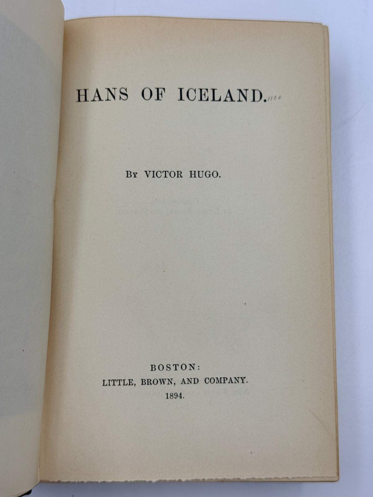 An open vintage book showing the title page for 'HANS OF ICELAND' by Victor Hugo, published by Little, Brown, and Company in Boston, 1994.