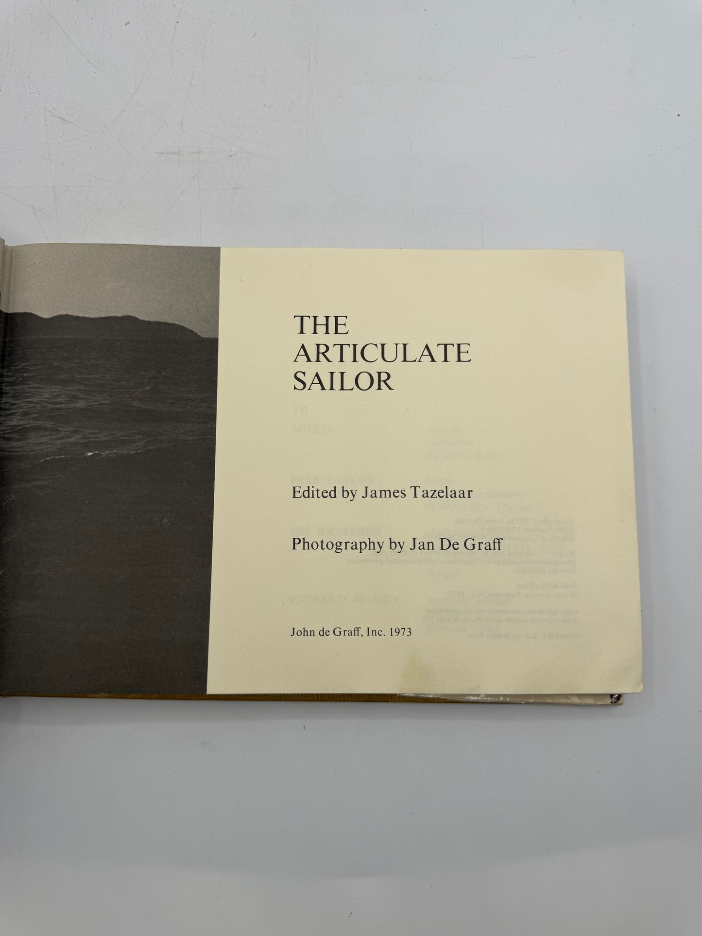 Book titled 'The Articulate Sailor' with a beige cover and black spine on a gray background