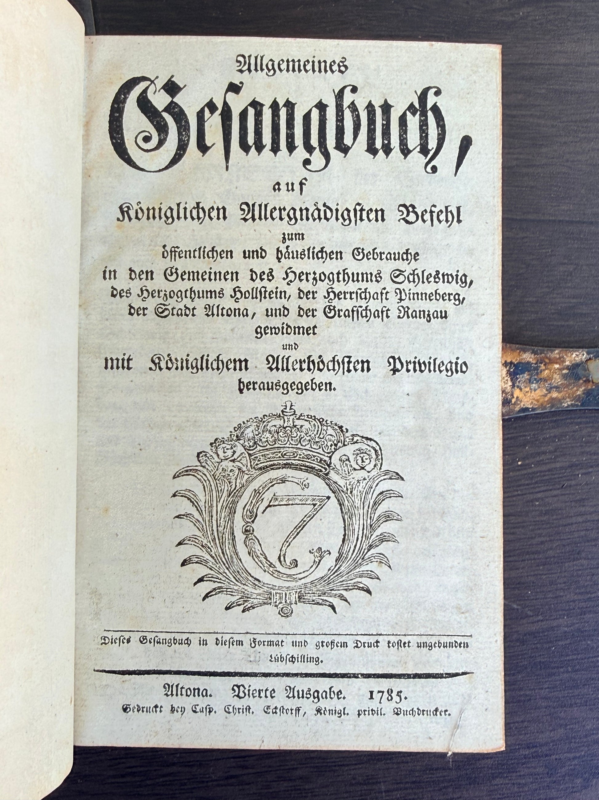 Vintage document with text and decorative elements on a dark surface
