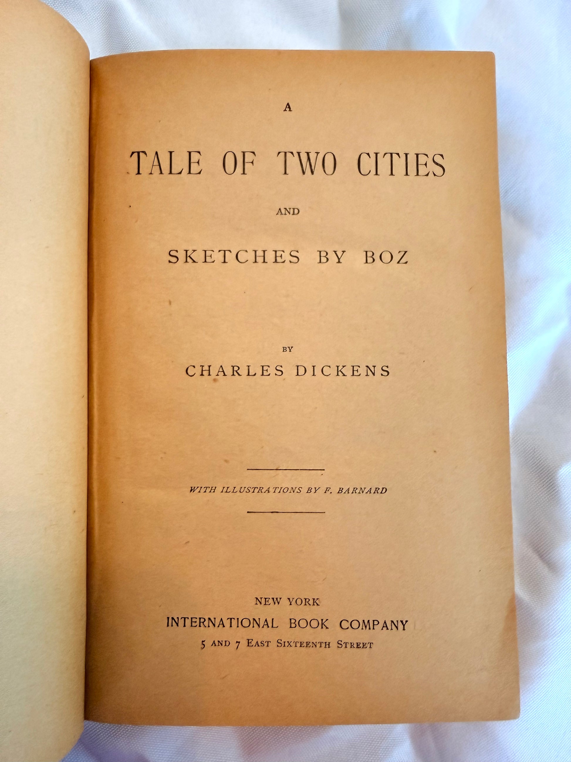 Title page of 'A Tale of Two Cities' by Charles Dickens on a white background