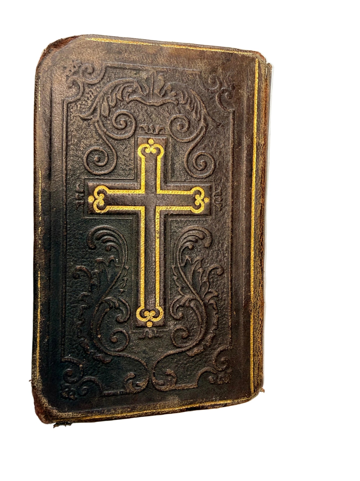 Decorative leather book with gold cross on a white background