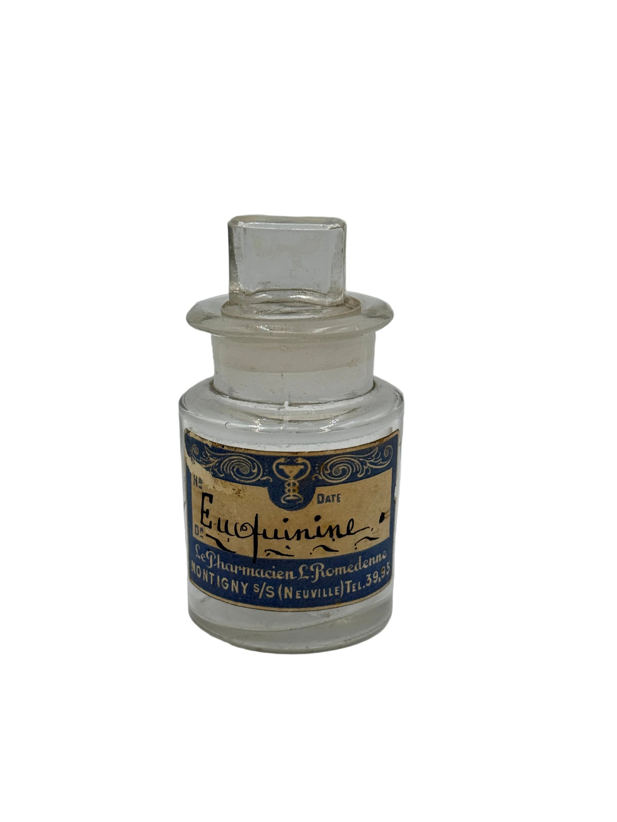 A vintage clear glass apothecary bottle with a stopper and a blue and gold label reading 'Eucalyptine' and 'Dutt', set against a plain light gray background.