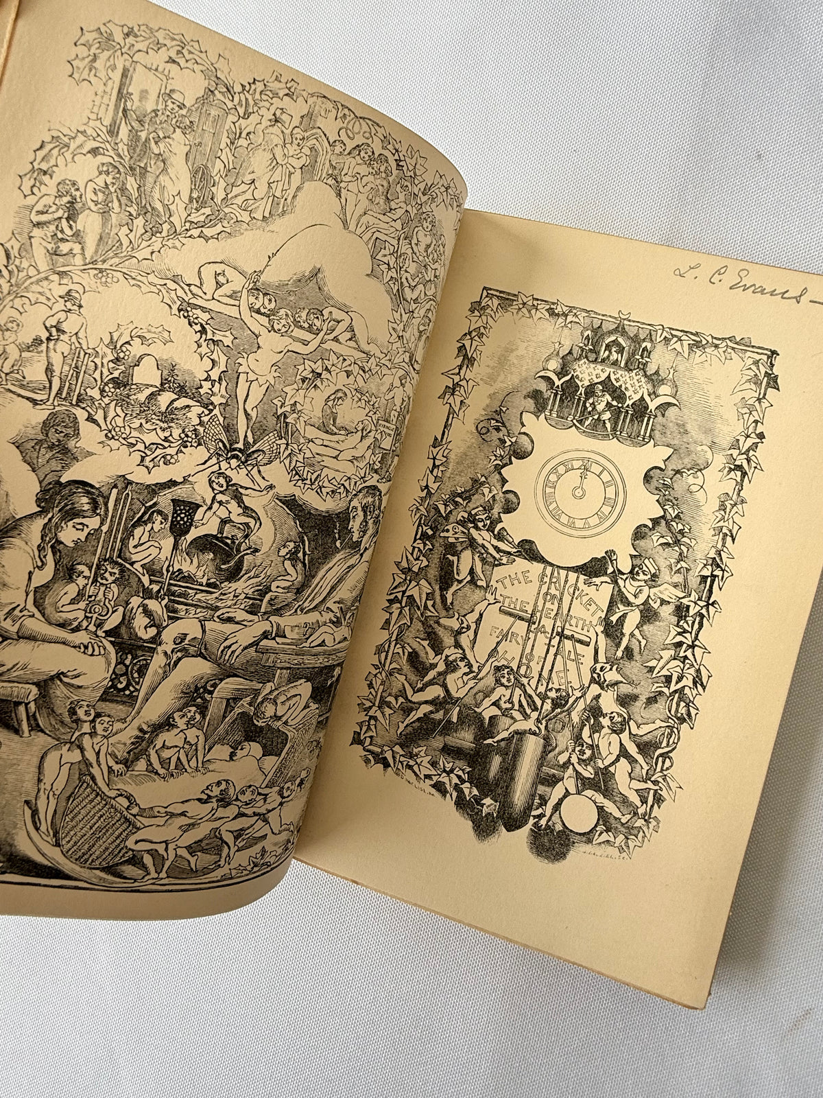 An open vintage book or album showing two illustrated pages with dense black ink drawings on aged cream paper. The left page contains a large fantasy or allegorical scene, and the right page features a central clock illustration surrounded by decorative figures and objects.