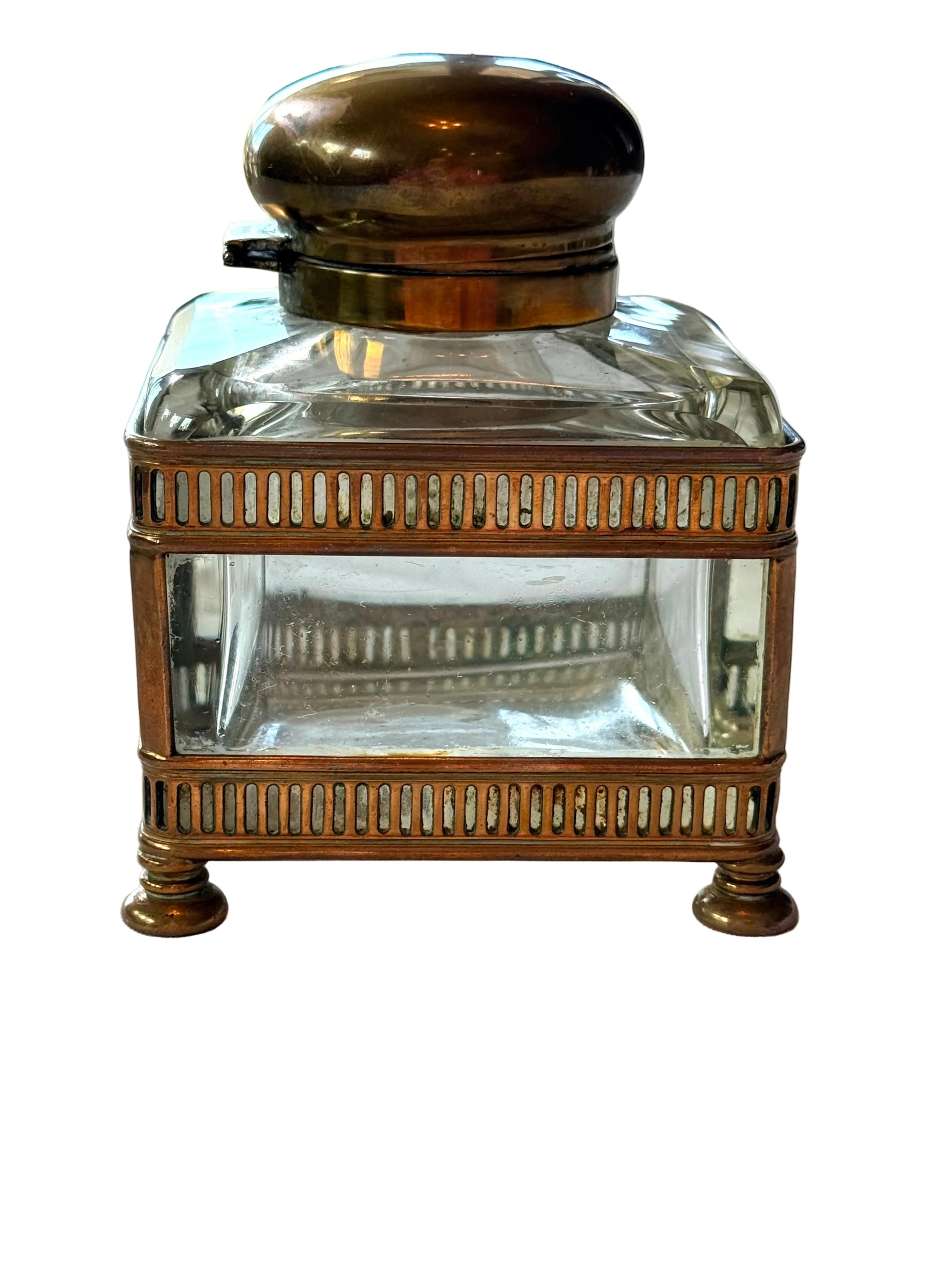 Vintage-style inkwell with brass base and lid on a white surface