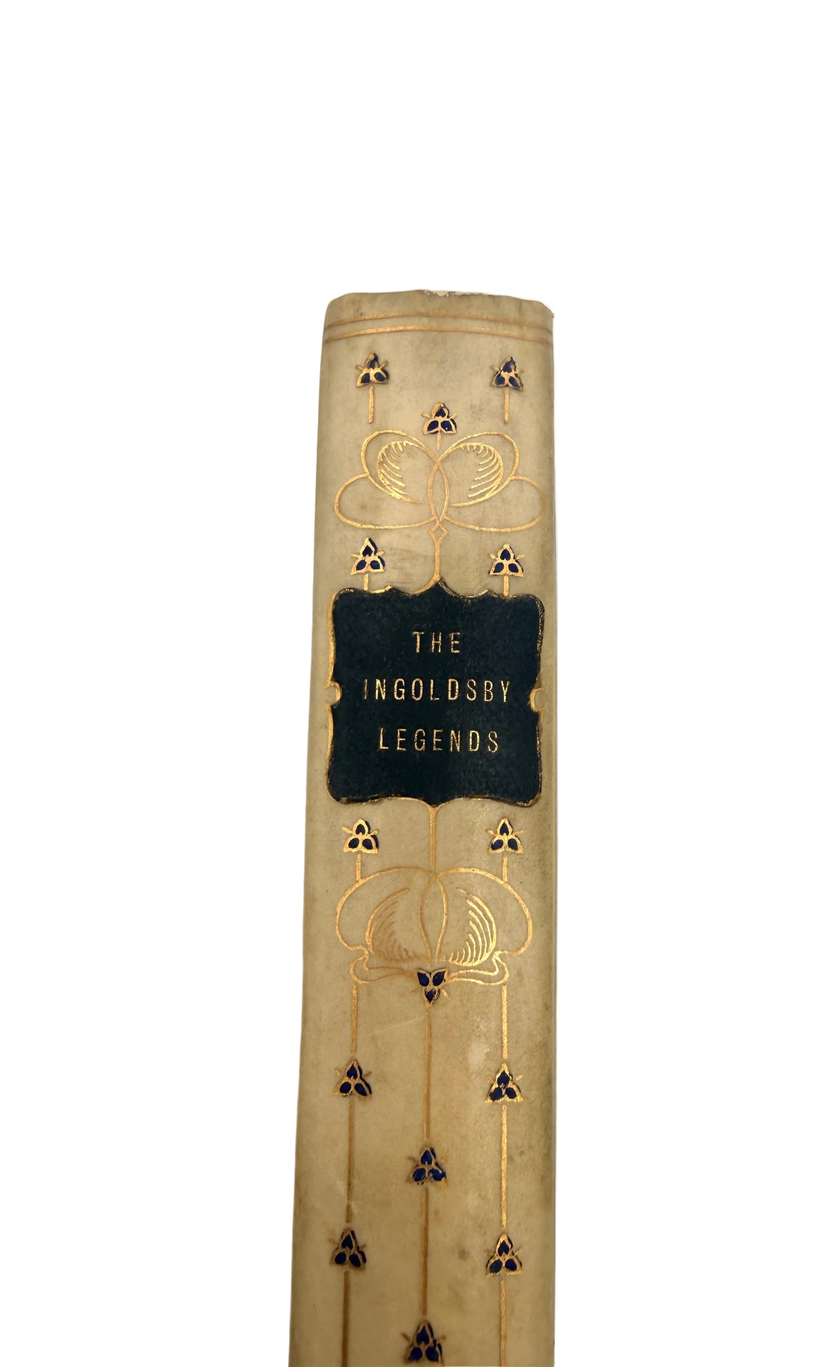 A close-up of a vintage book spine with a beige cloth cover, gold decorative filigree, and a central black label reading 'THE INGOLDSBY LEGENDS'.