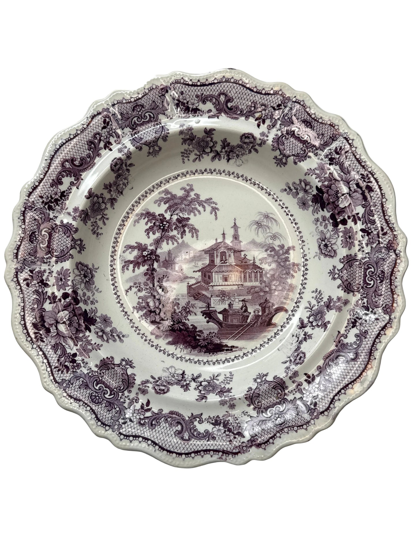Decorative purple floral plate on a white background