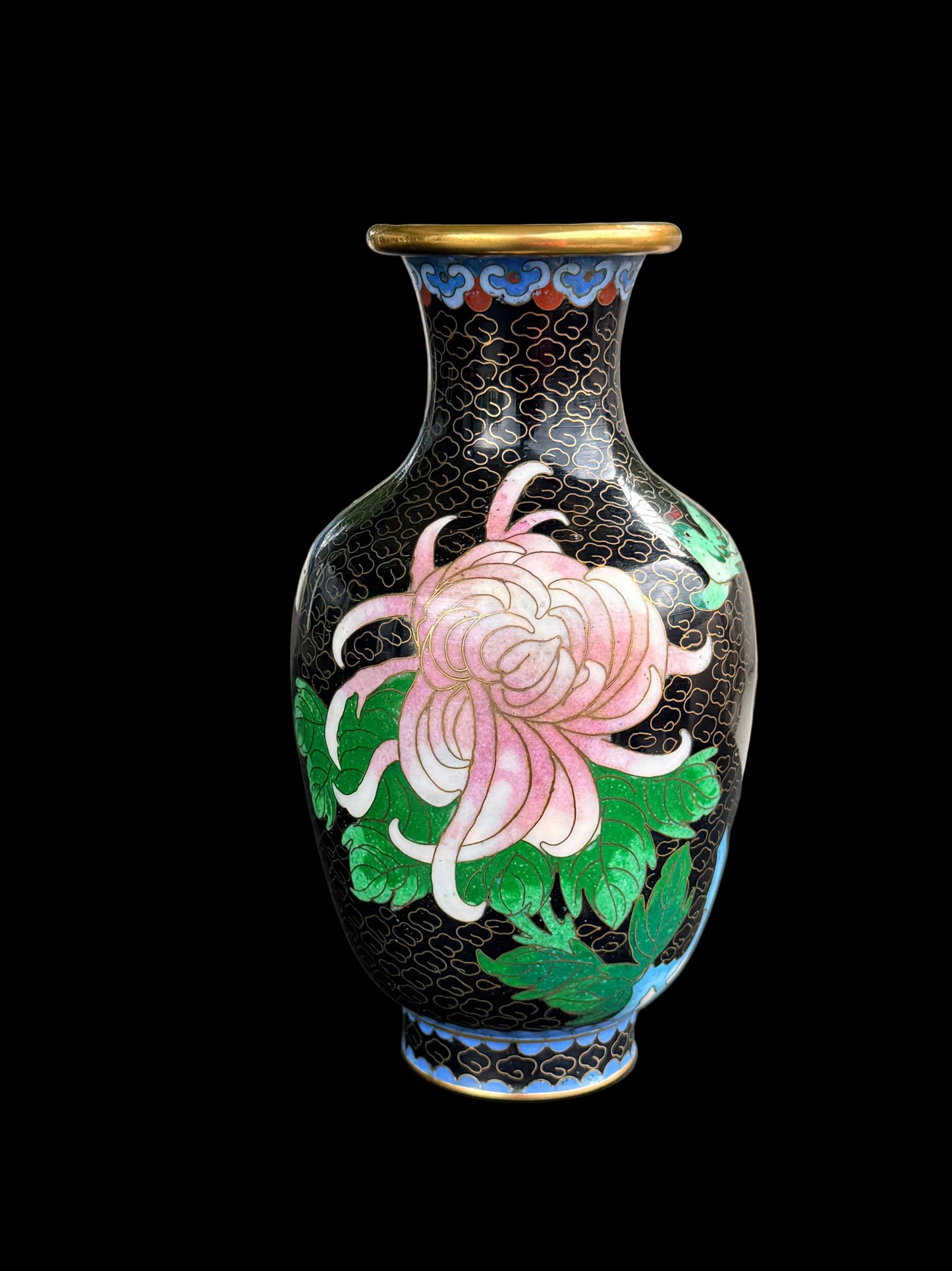 Decorative vase with floral design on a black surface