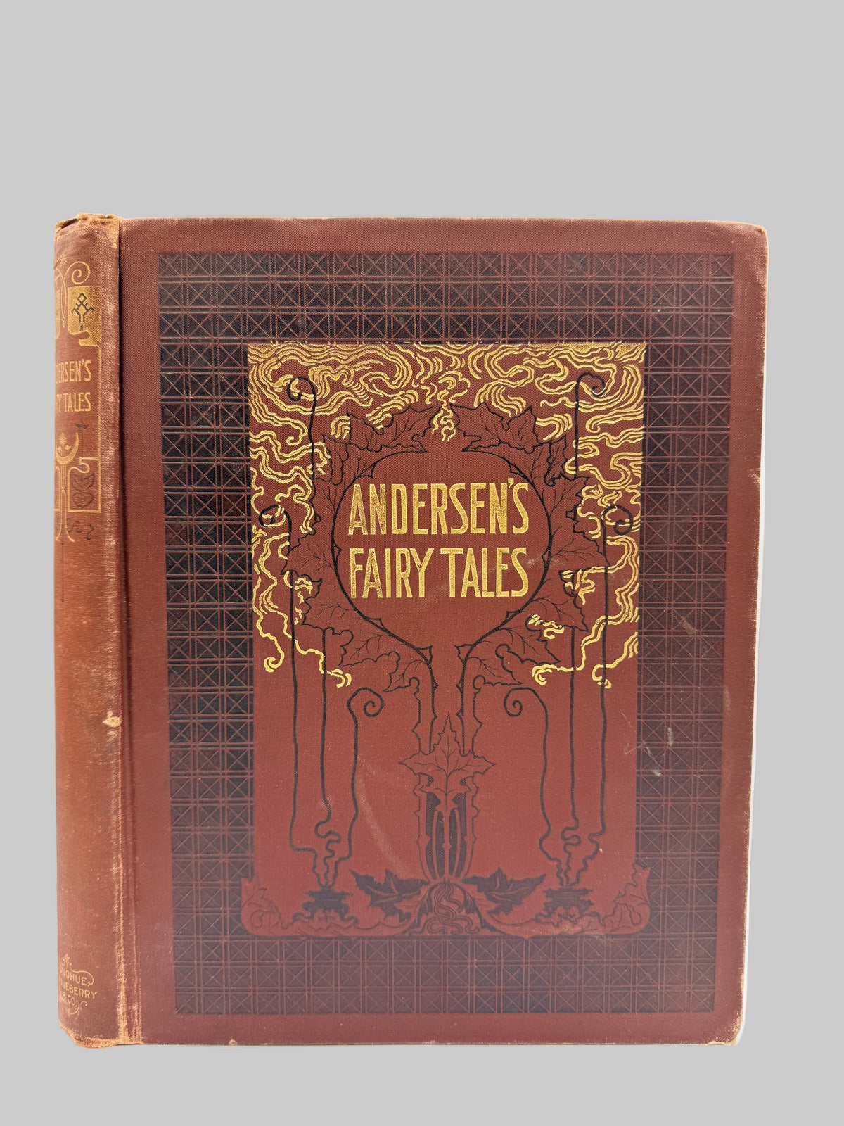 A vintage hardcover book titled 'Andersen's Fairy Tales' with a reddish-brown cover and ornate gold decorative border, photographed against a plain white background.