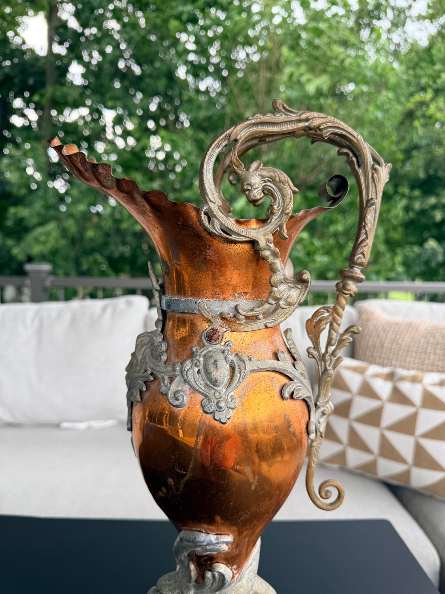 Decorative metal horse head sculpture with intricate details outdoors