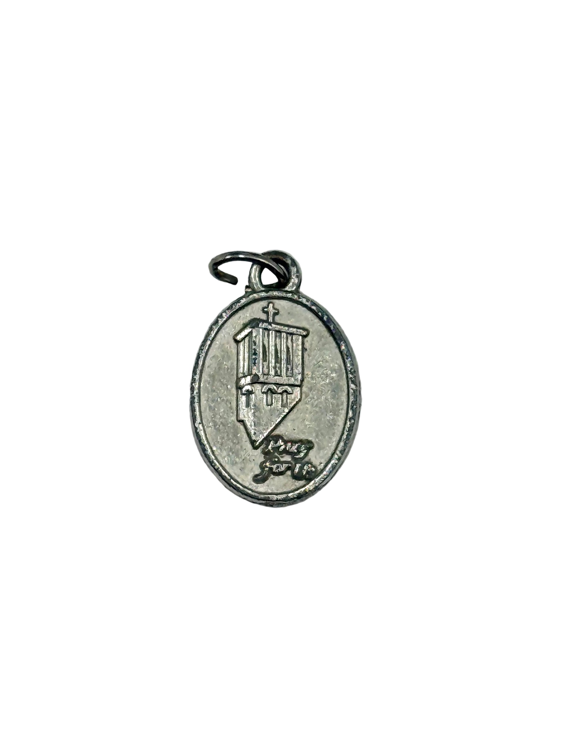 Silver pendant with intricate design on a light gray background