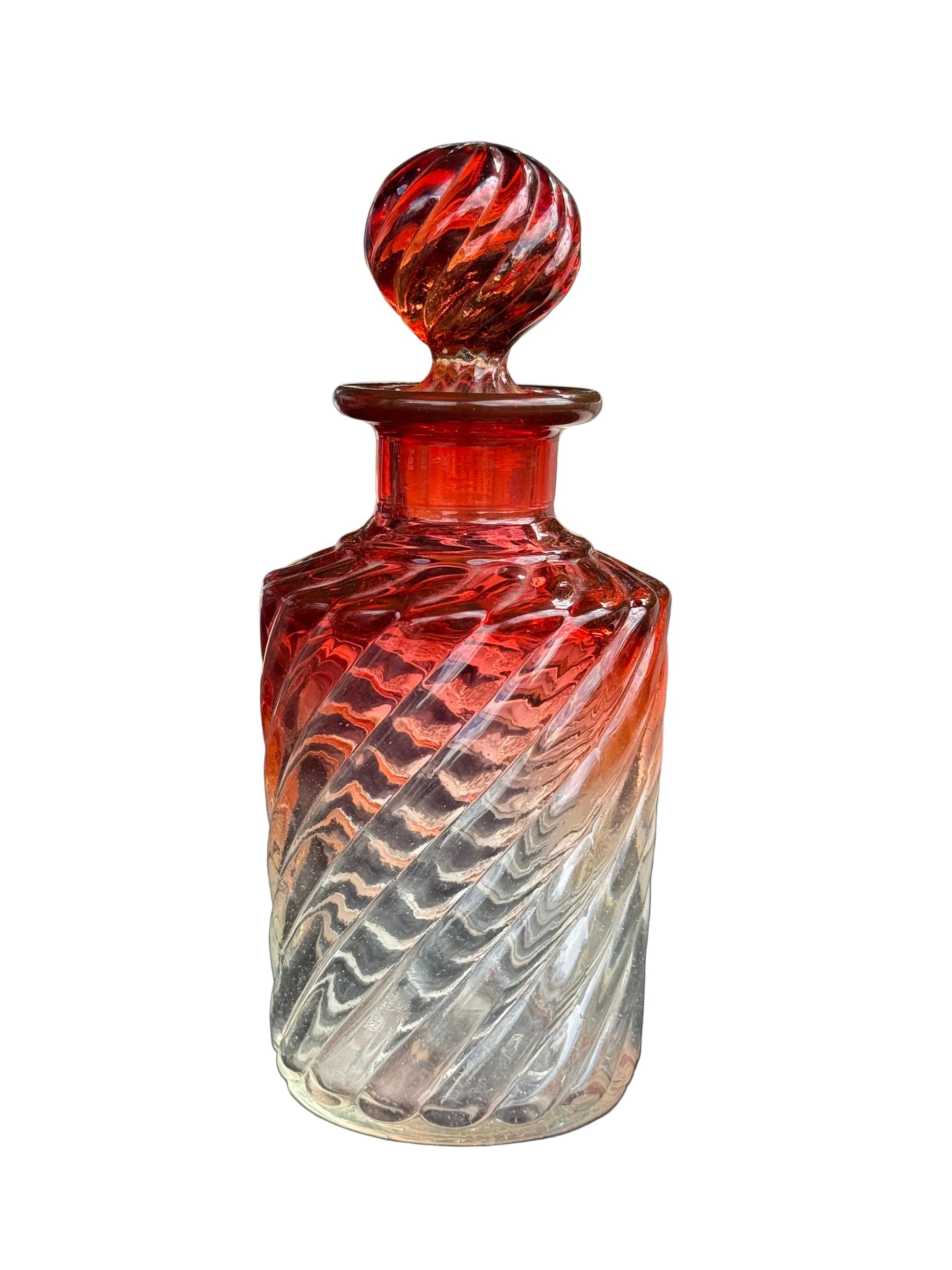 Decorative glass bottle with a textured design on a blurred background