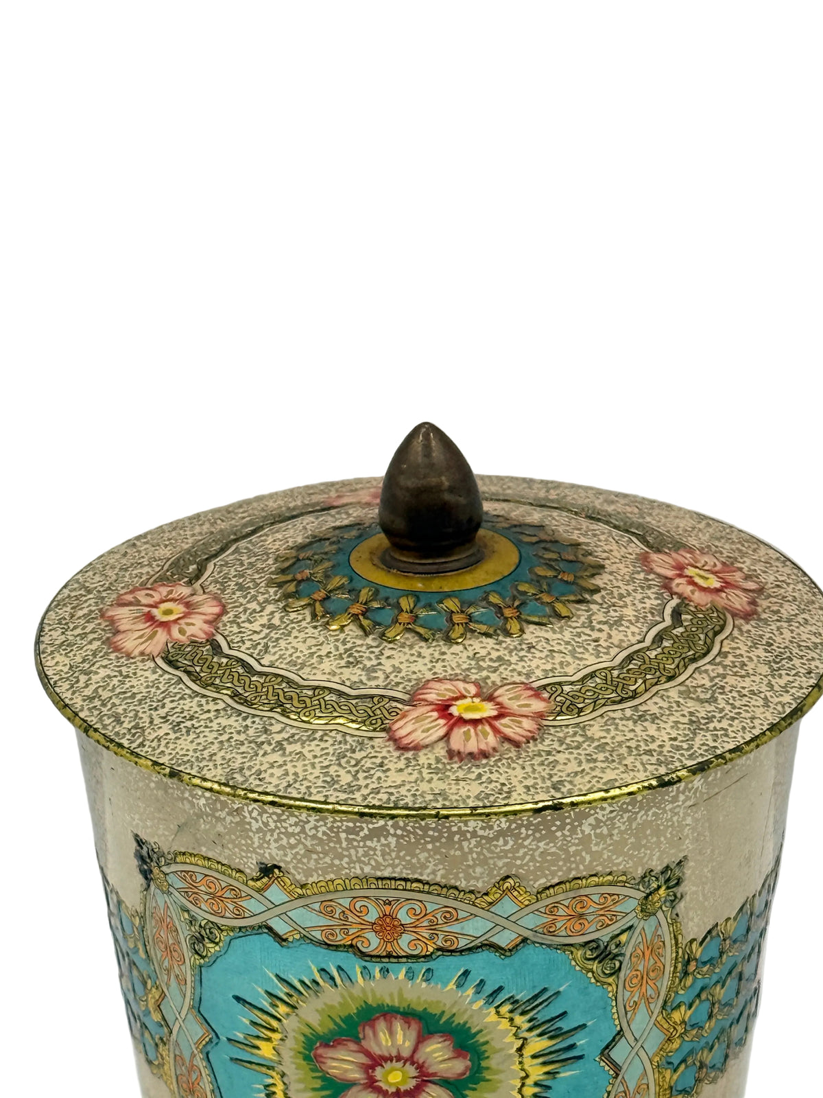 An ornate lidded ceramic jar with a pointed dark brown wooden knob, decorated with intricate hand-painted floral and geometric patterns in turquoise, gold, pink, and beige.
