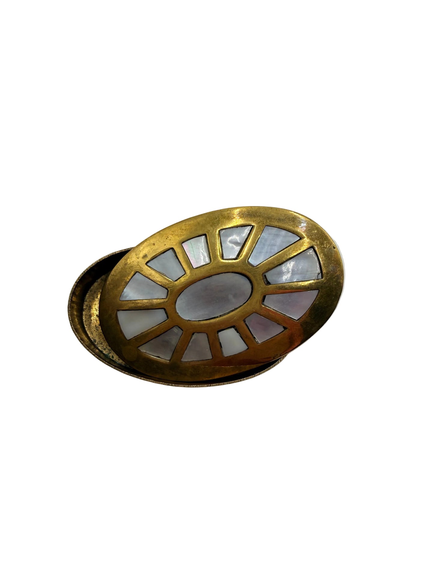 Decorative brass wall fixture with a white central circle on a light gray background