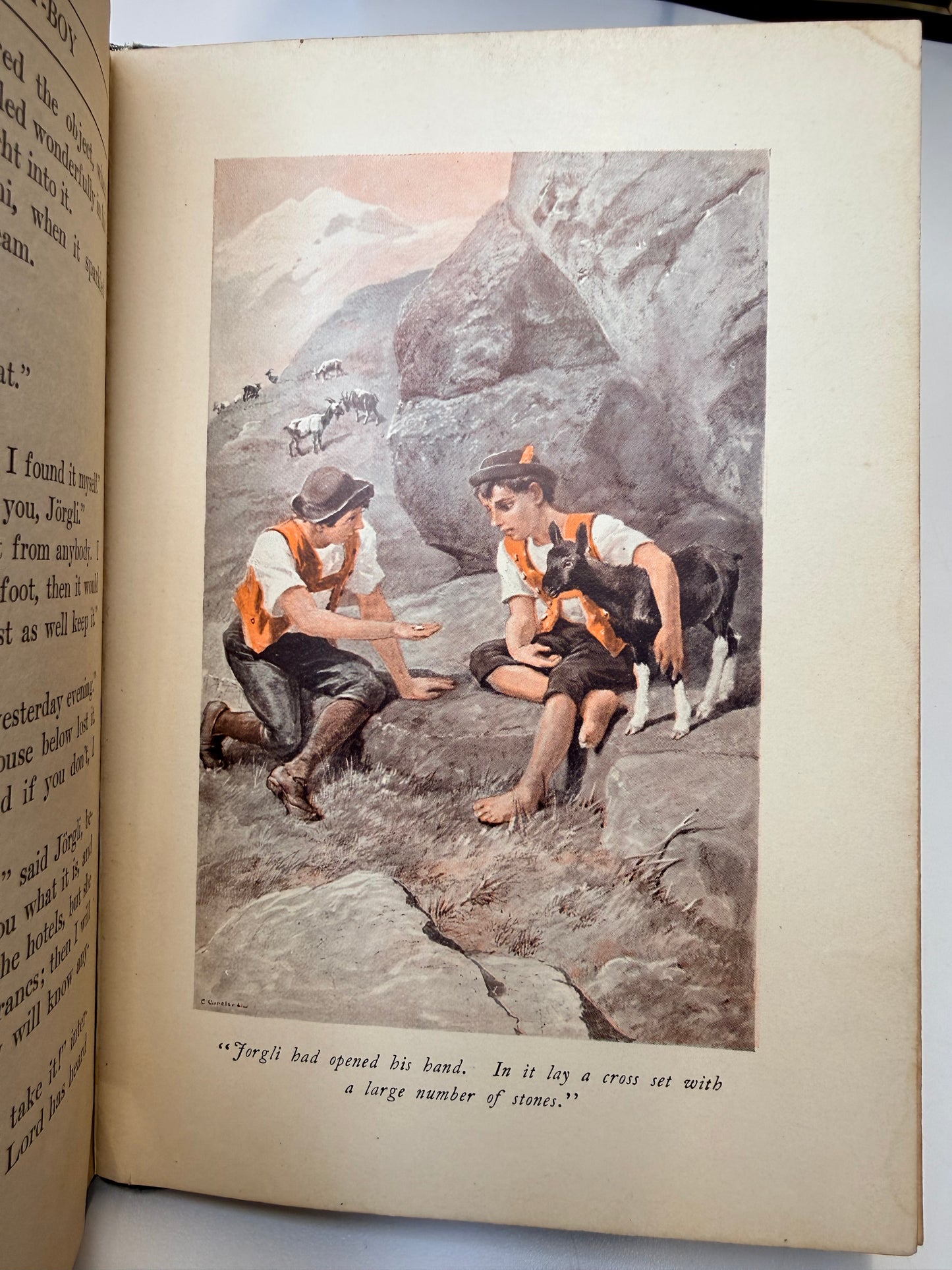 Open book with a vintage illustration of people climbing on rocky terrain.