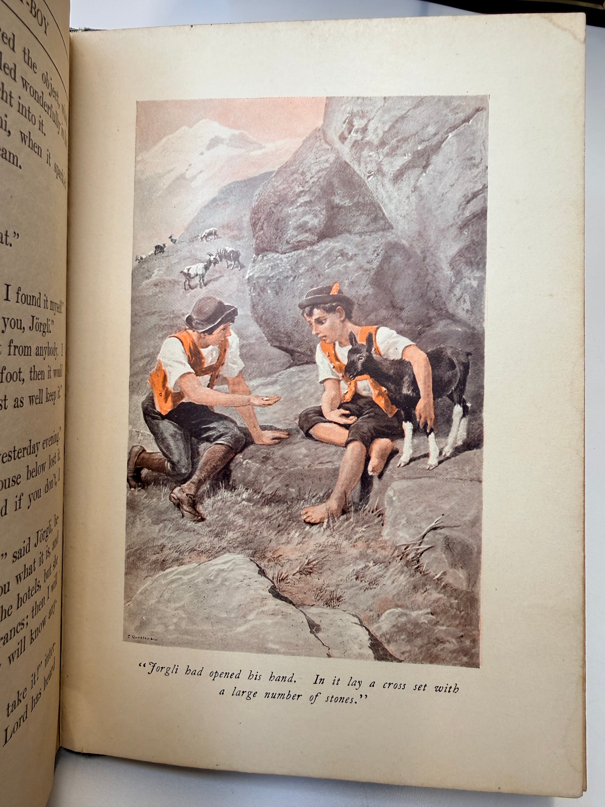 Open book with a vintage illustration of people climbing on rocky terrain.