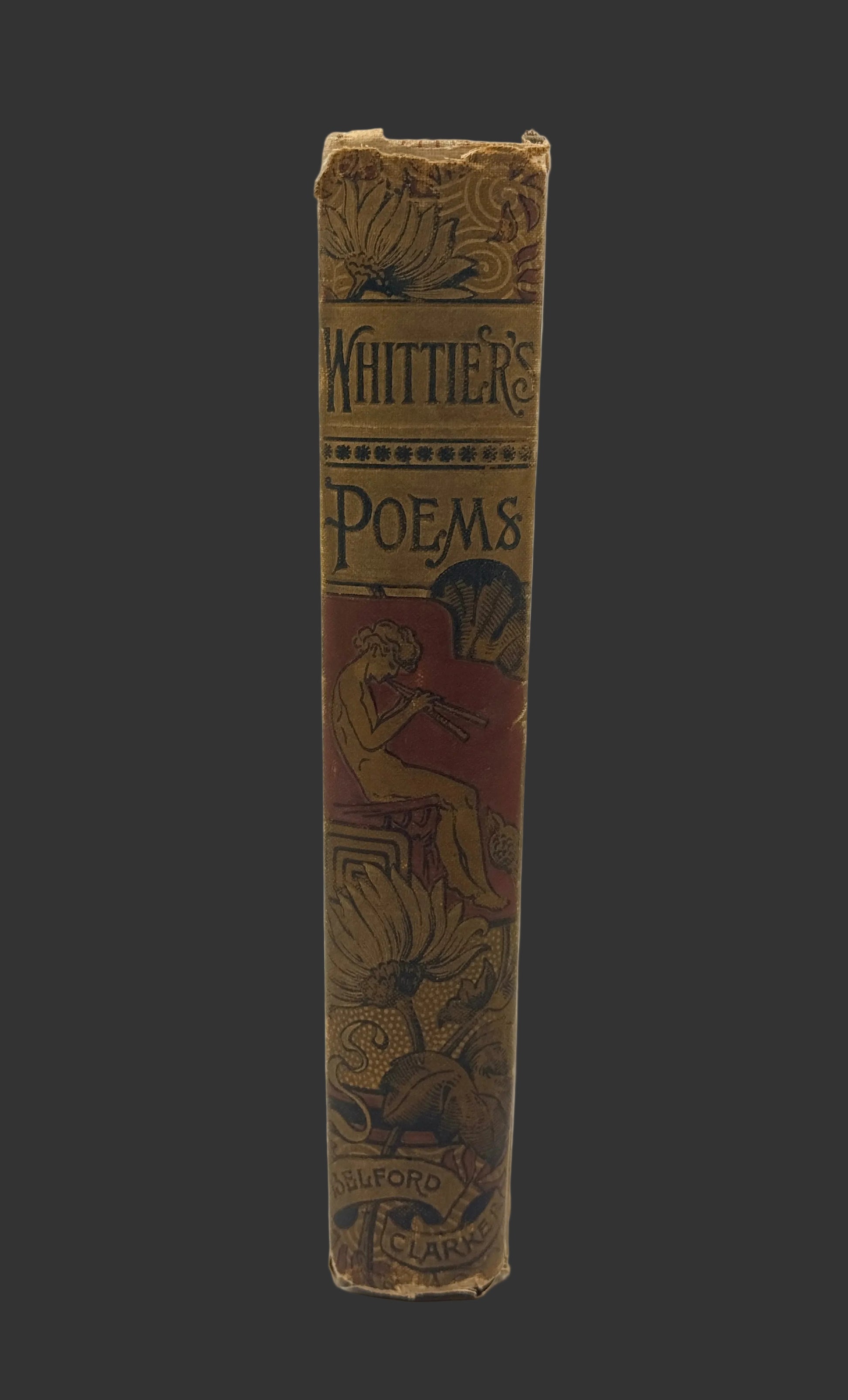 An antique book spine titled 'Whittier's Poems' with ornate gold and red decorative illustrations on a light gray background.
