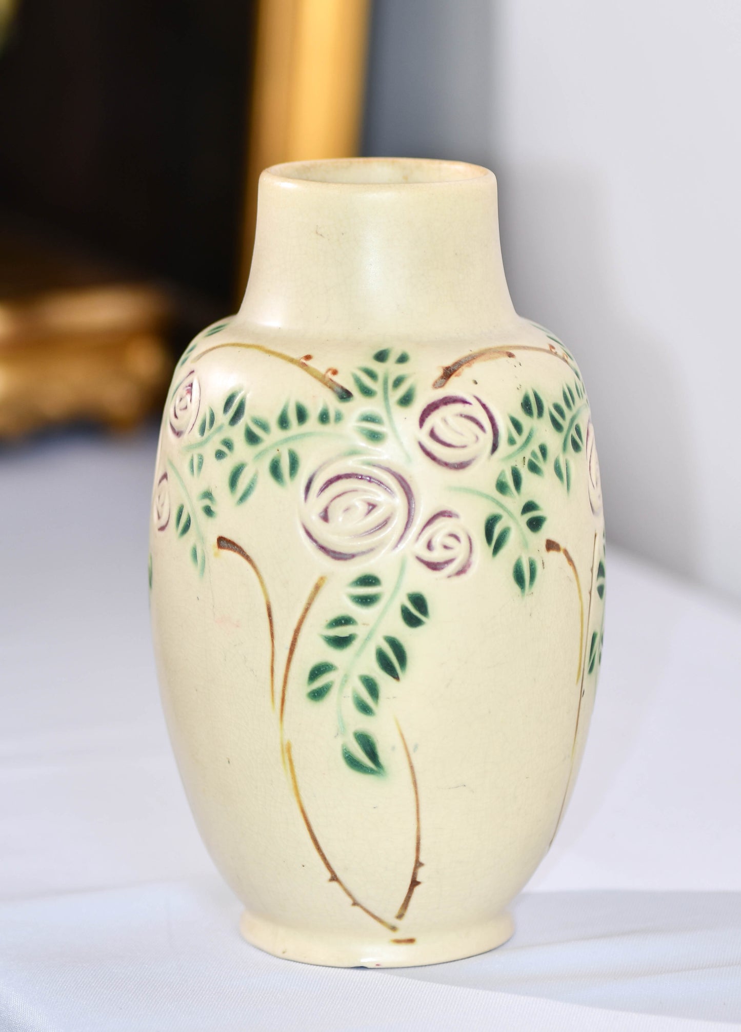 Ceramic vase with floral design on a white surface