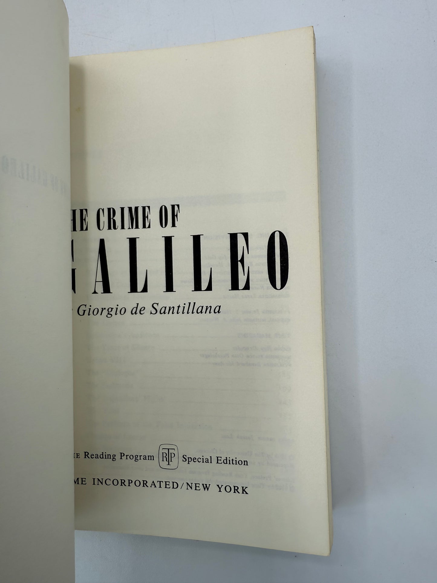 Book titled 'The Crime of Galileo' by Giorgio de Santillana on a light gray background
