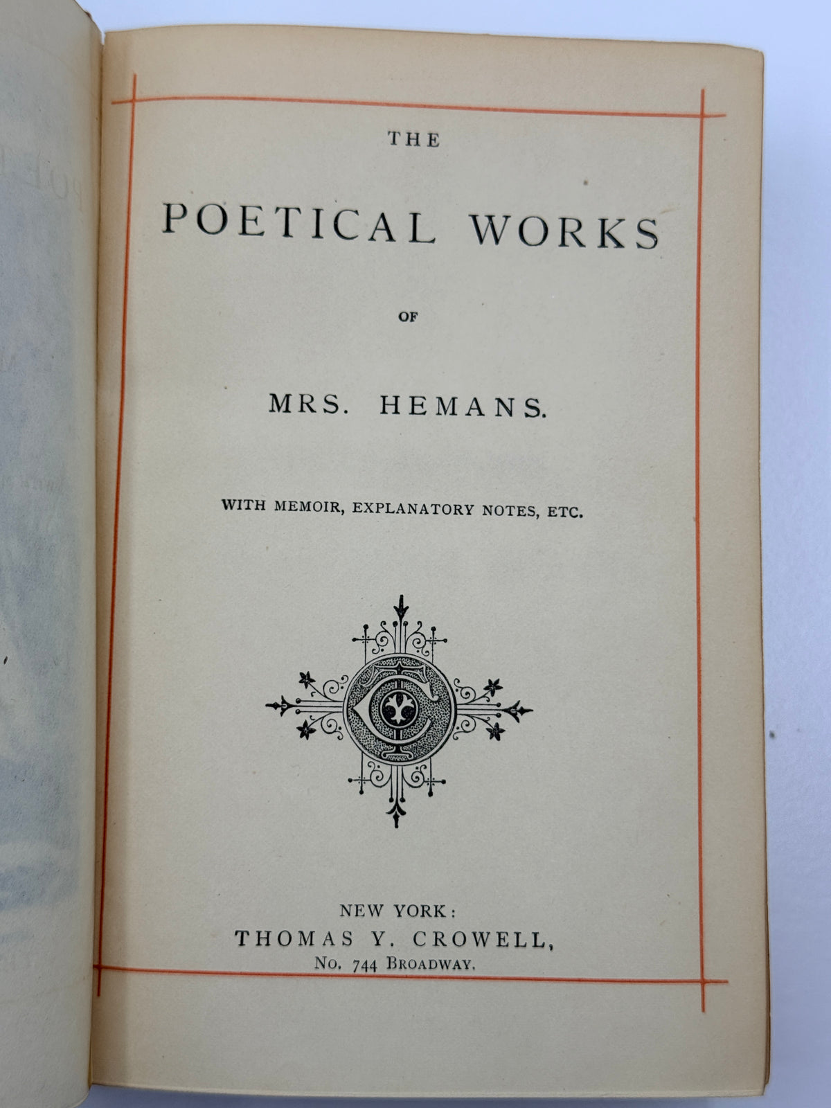 An open vintage book showing the title page for 'The Poetical Works of Mrs. Hemans' with decorative black text and illustration on aged cream paper, photographed against a white background.