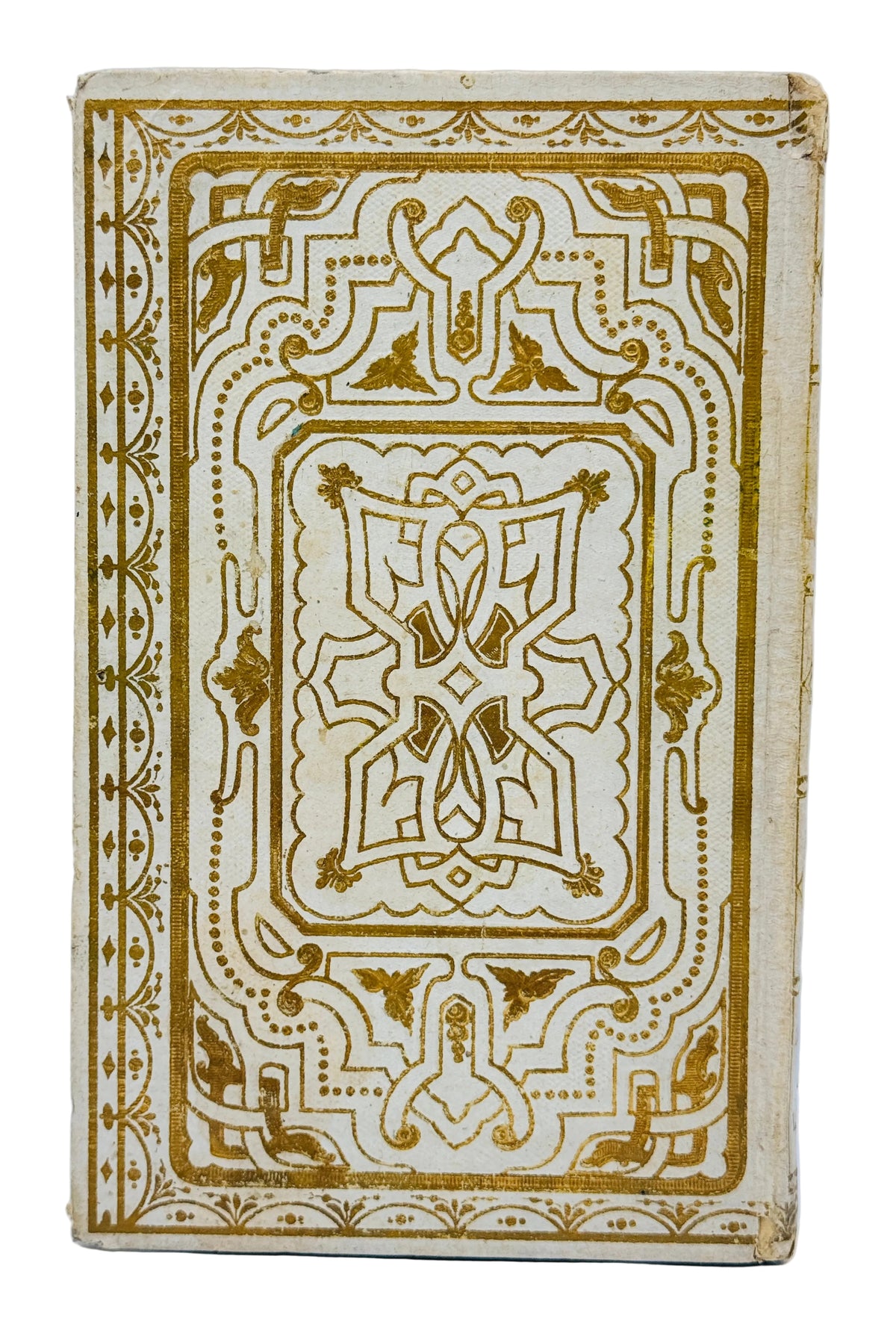 An antique decorative book or notebook with an ornate gold foil geometric border design on a cream-colored cover, photographed against a plain light background.