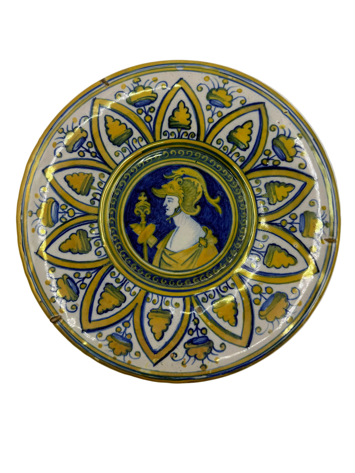 A round decorative ceramic plate featuring a central classical bust in blue and gold, surrounded by a blue and gold floral mandala pattern on a white background.
