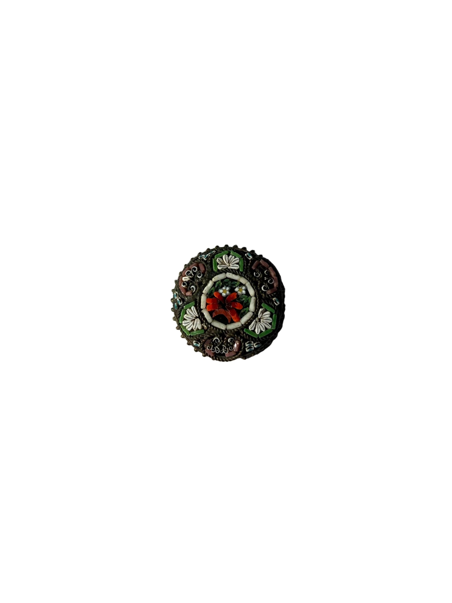 Decorative brooch with a circular design on a textured fabric background