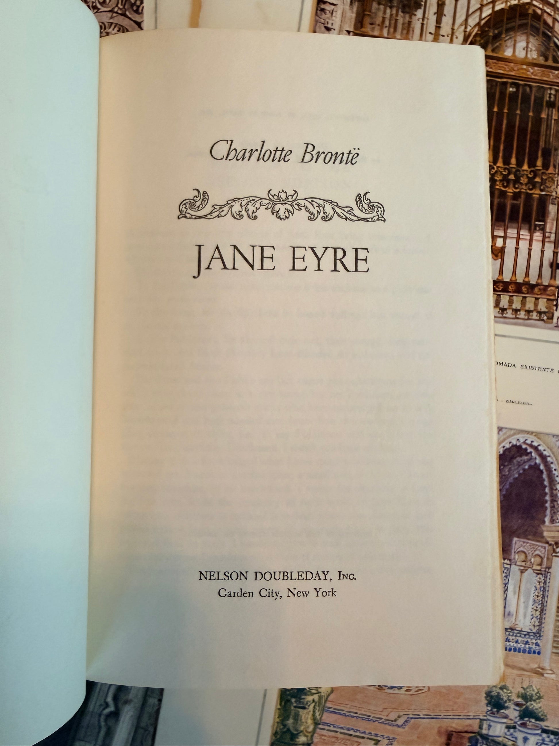 Book titled 'Jane Eyre' by Charlotte Bronte on a textured surface with architectural designs.