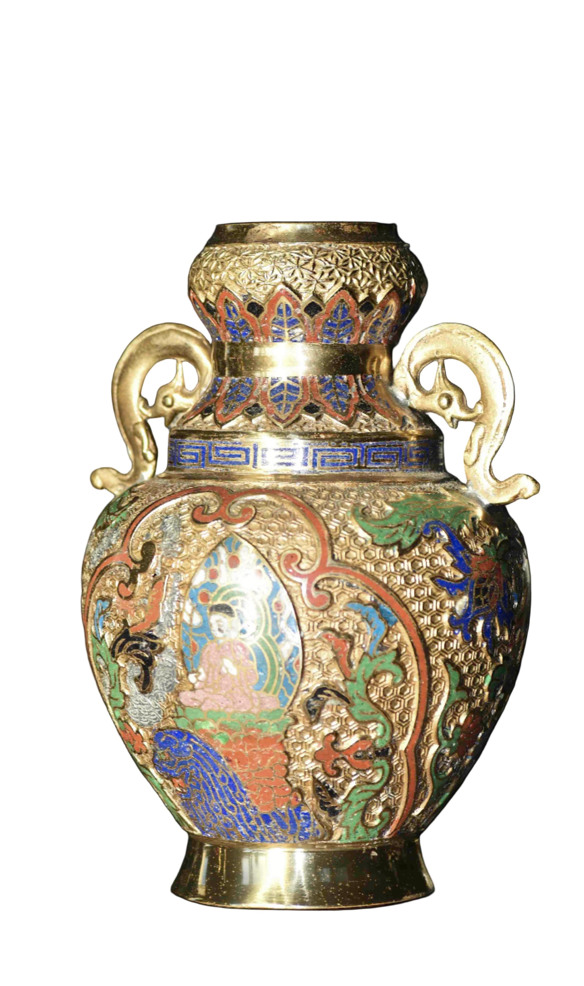 An ornate cloisonne gilded vase with colorful enamel patterns and handles shaped like serpents.