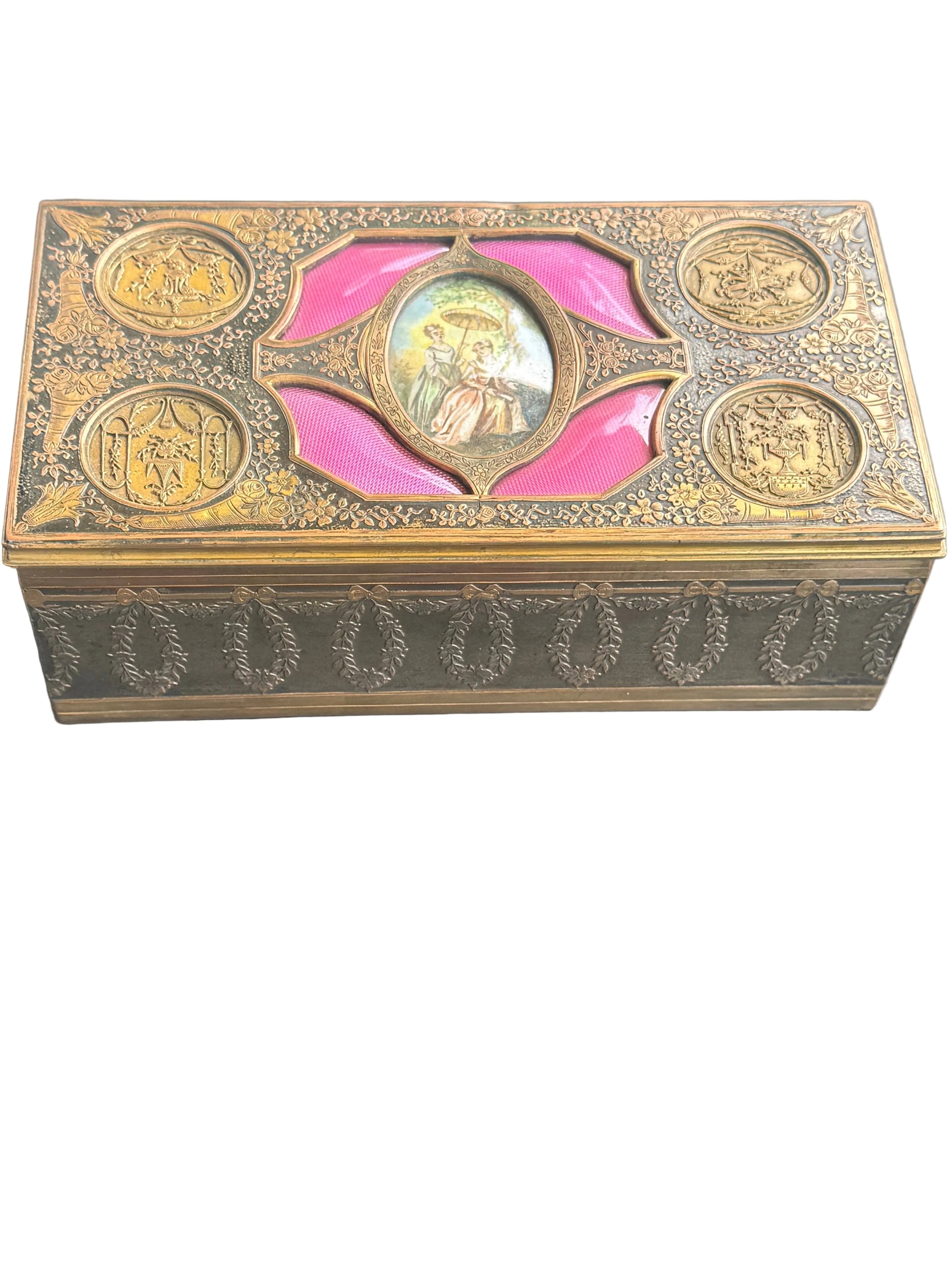 Decorative box with gold accents and pink center on a gray background