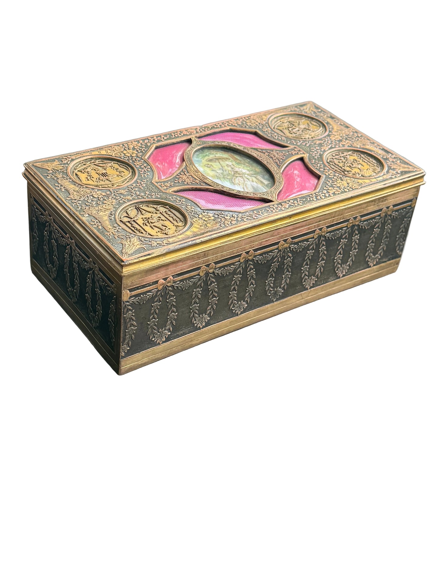 Decorative box with intricate designs and colored stones on a gray surface