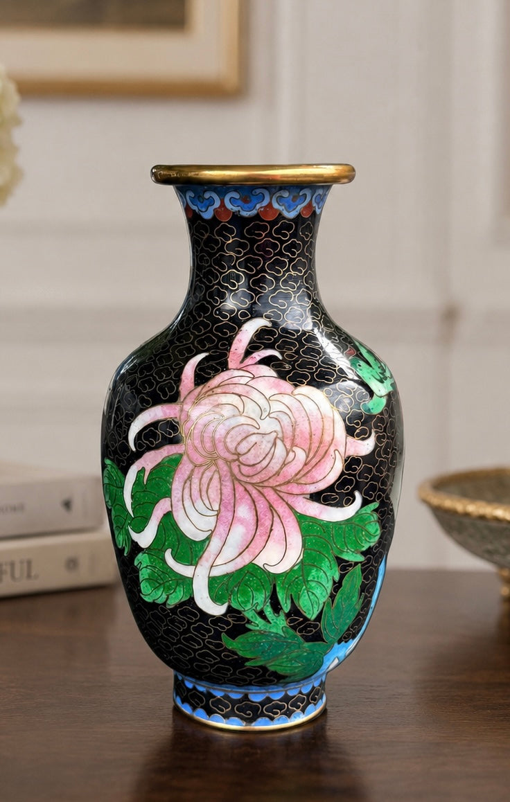 Decorative vase with floral design on a wooden surface