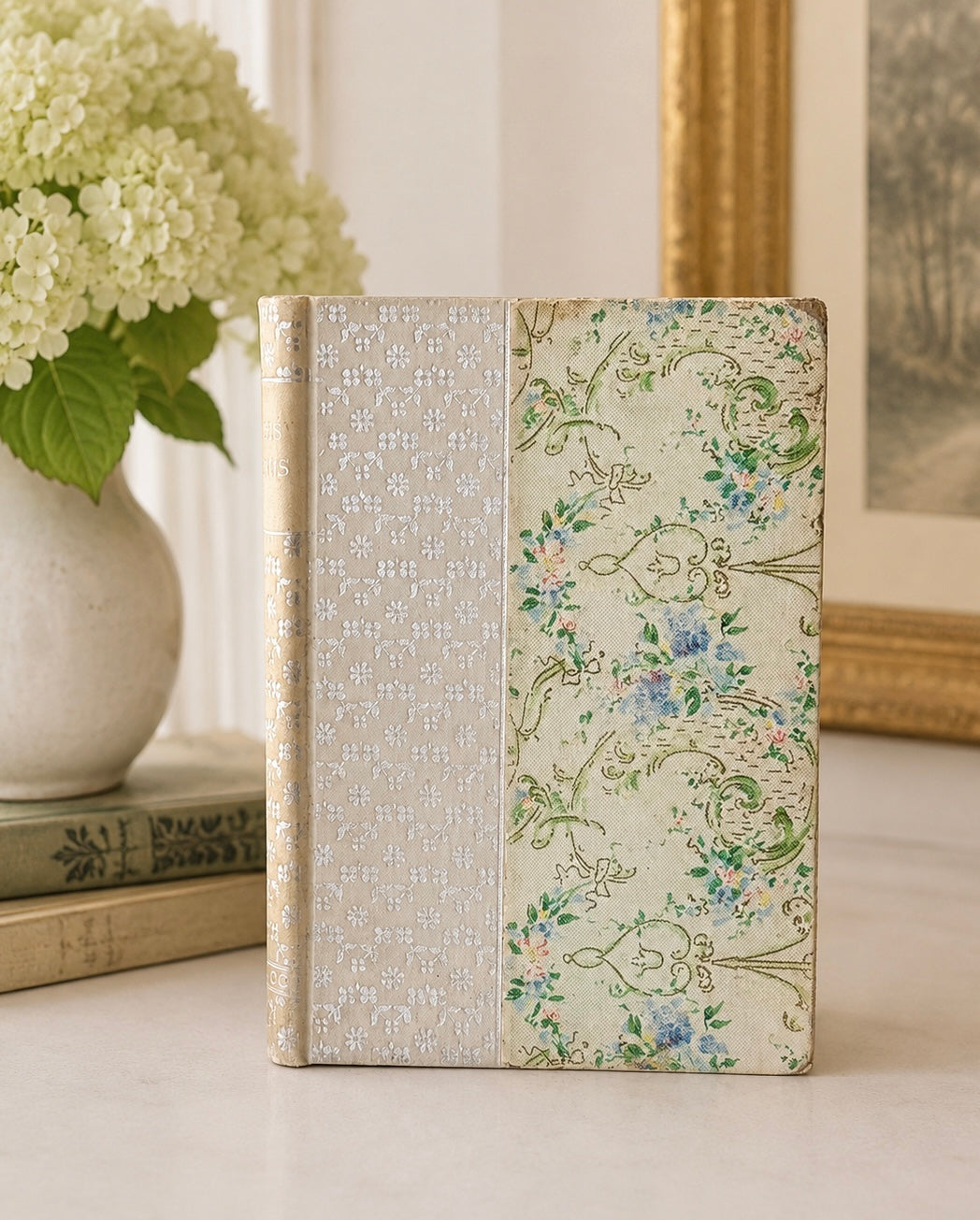 Decorative notebook with floral and textured design on a neutral background