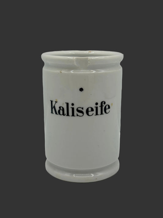 A white ceramic container with the word 'Kaliseife' printed in black on the front, photographed against a plain light gray background.