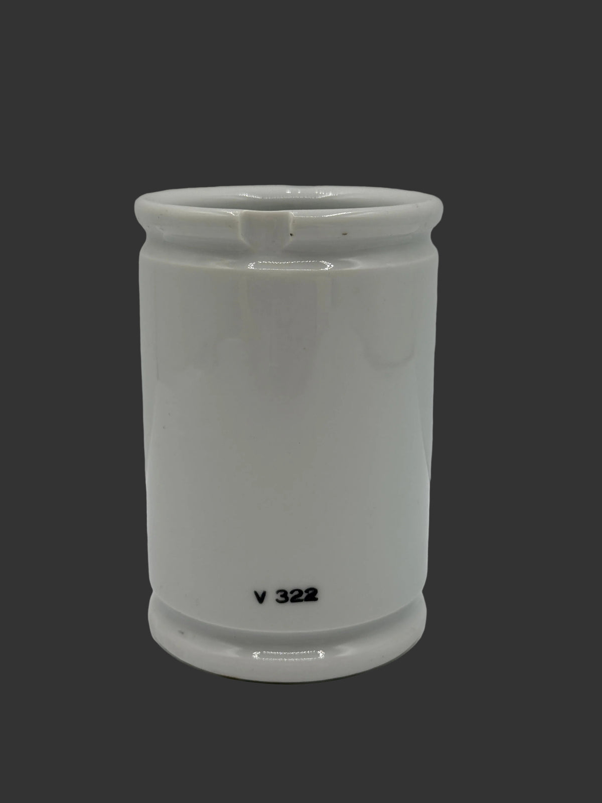 A white ceramic cylindrical cup or tumbler with a small black printed identifier 'V 322' near the base, set against a plain light gray background