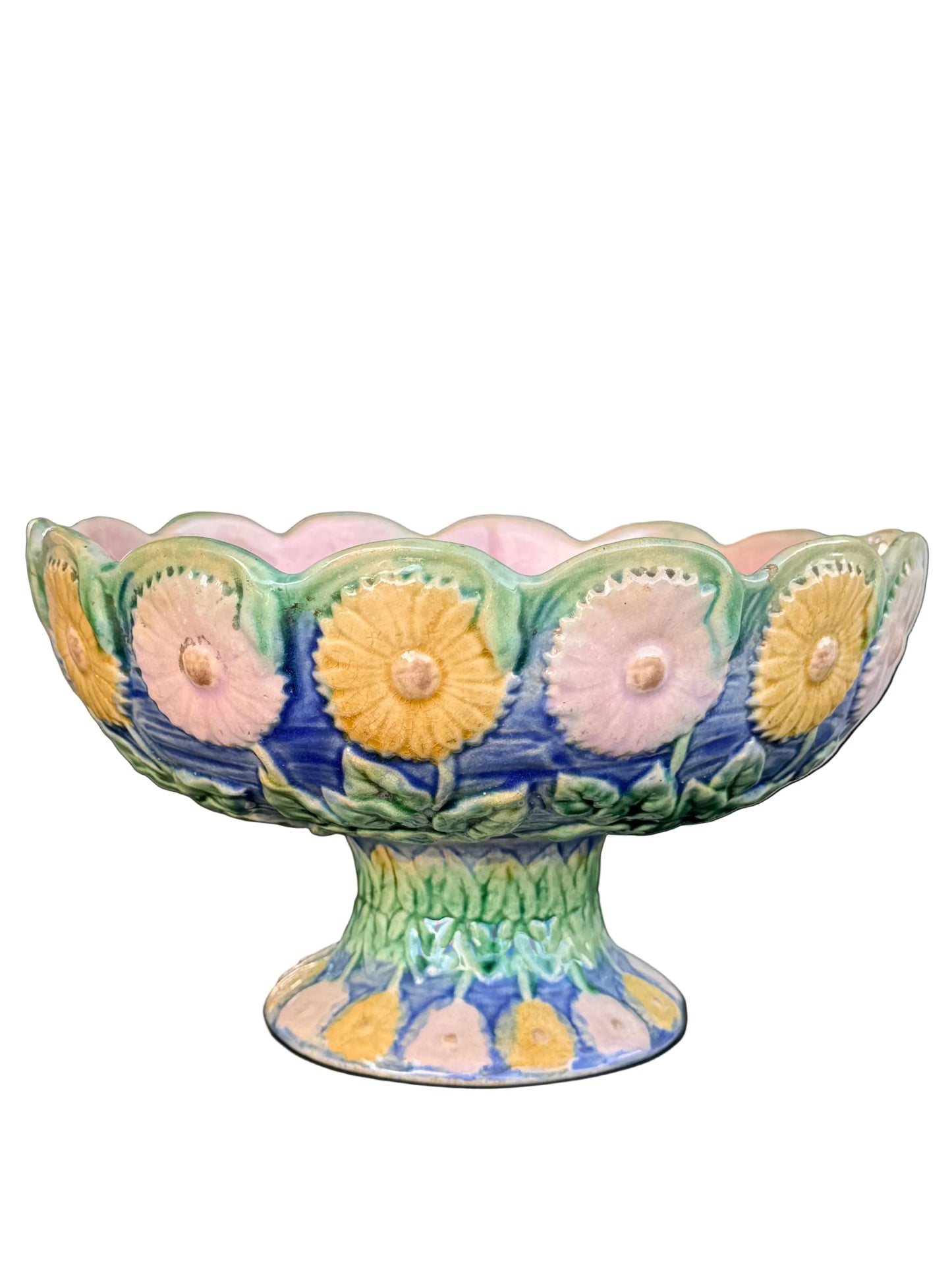 Decorative ceramic bowl with floral patterns on a table outdoors.