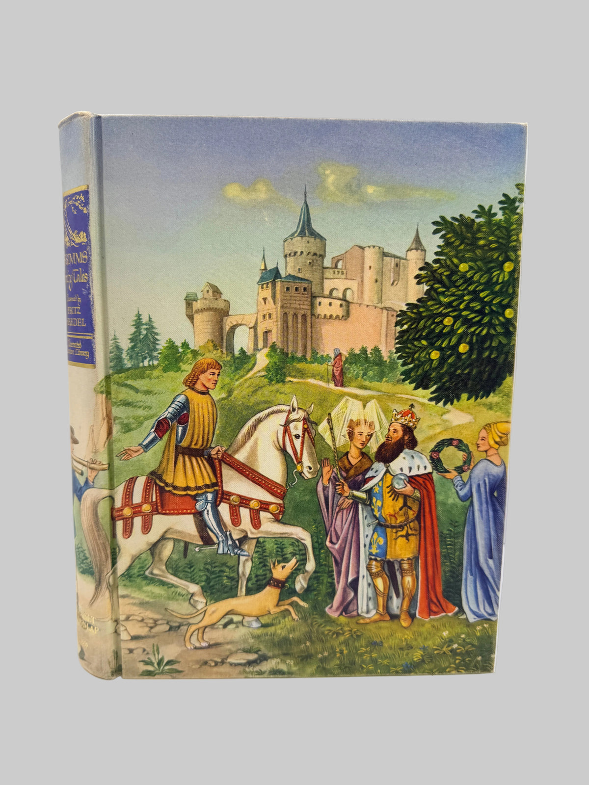 A vintage hardcover book with a colorful medieval illustration on the cover, showing a knight on a white horse, figures in robes, and a castle in the background. The book is photographed upright against a plain white studio background.