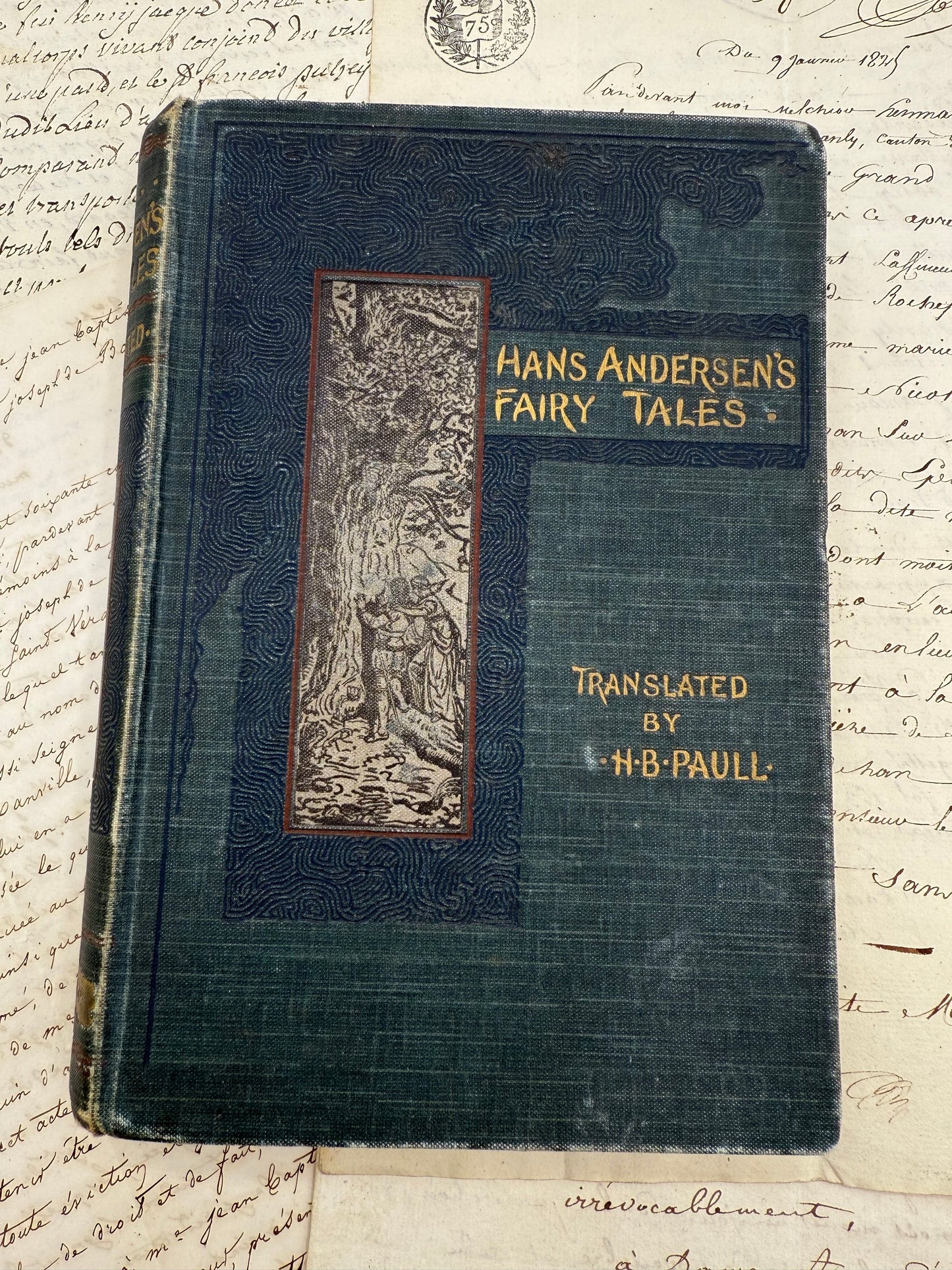 Vintage book titled 'Hans Andersen's Fairy Tales' on a textured paper background