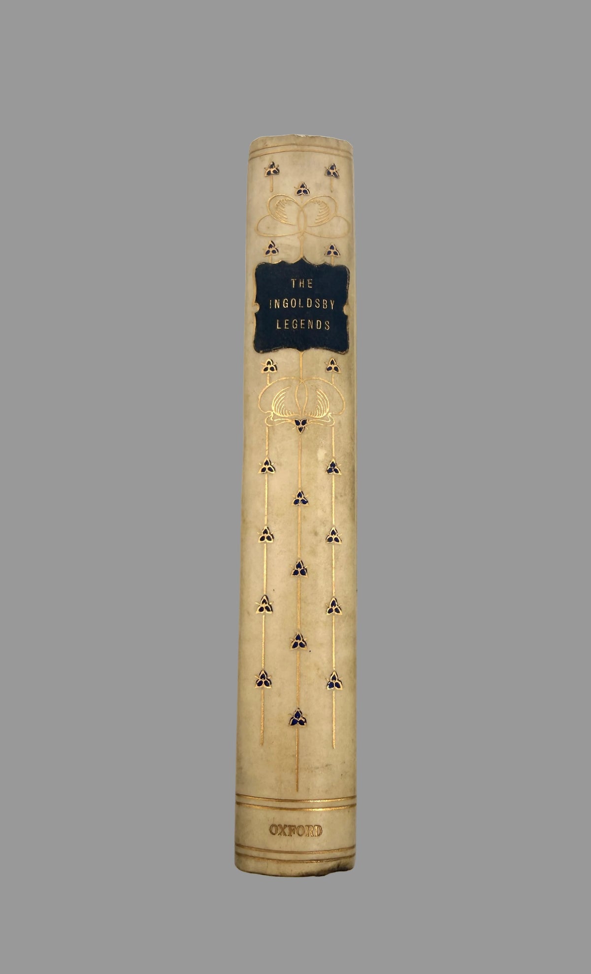 The front title page and decorative spine of the book 'The Incredible Legends' by Oxford, featuring a cream-colored cover with gold foil details and a black central label.
