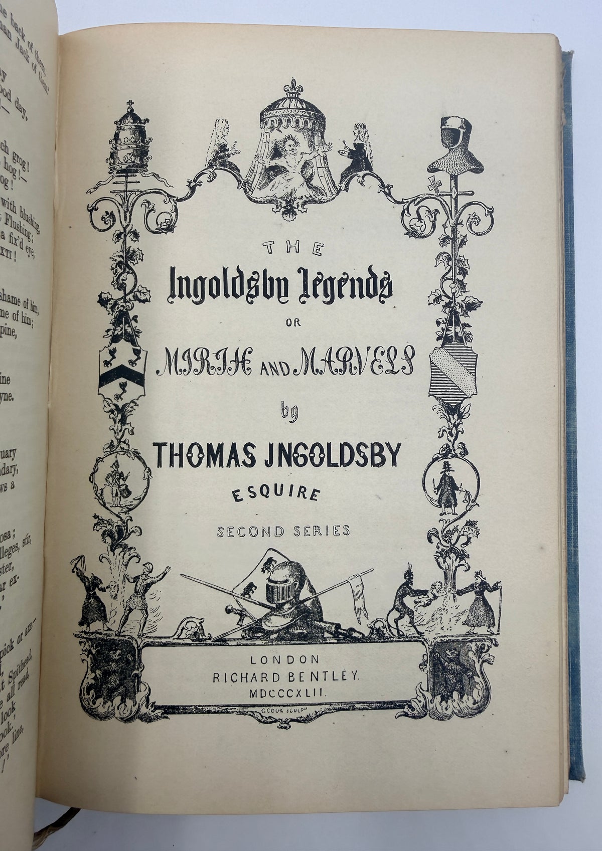 An open vintage book showing the title page of 'The Ingoldshin Legenda or Marie and Mervell' by Thomas Jngoldsby, Esquire, with ornate black decorative border illustrations on aged cream paper.