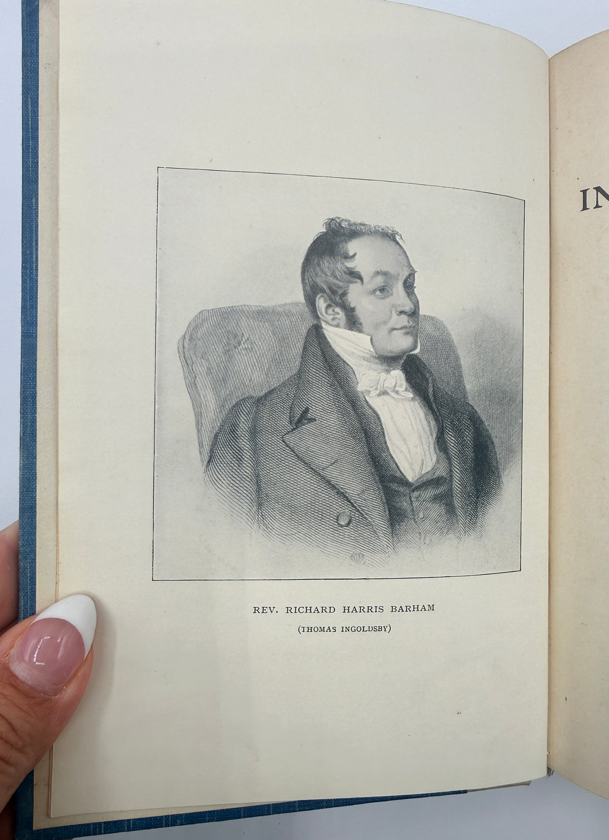 An open vintage book showing a black-and-white engraved portrait of Rev. Richard Harris Barham on the left page, with a hand holding the left edge.